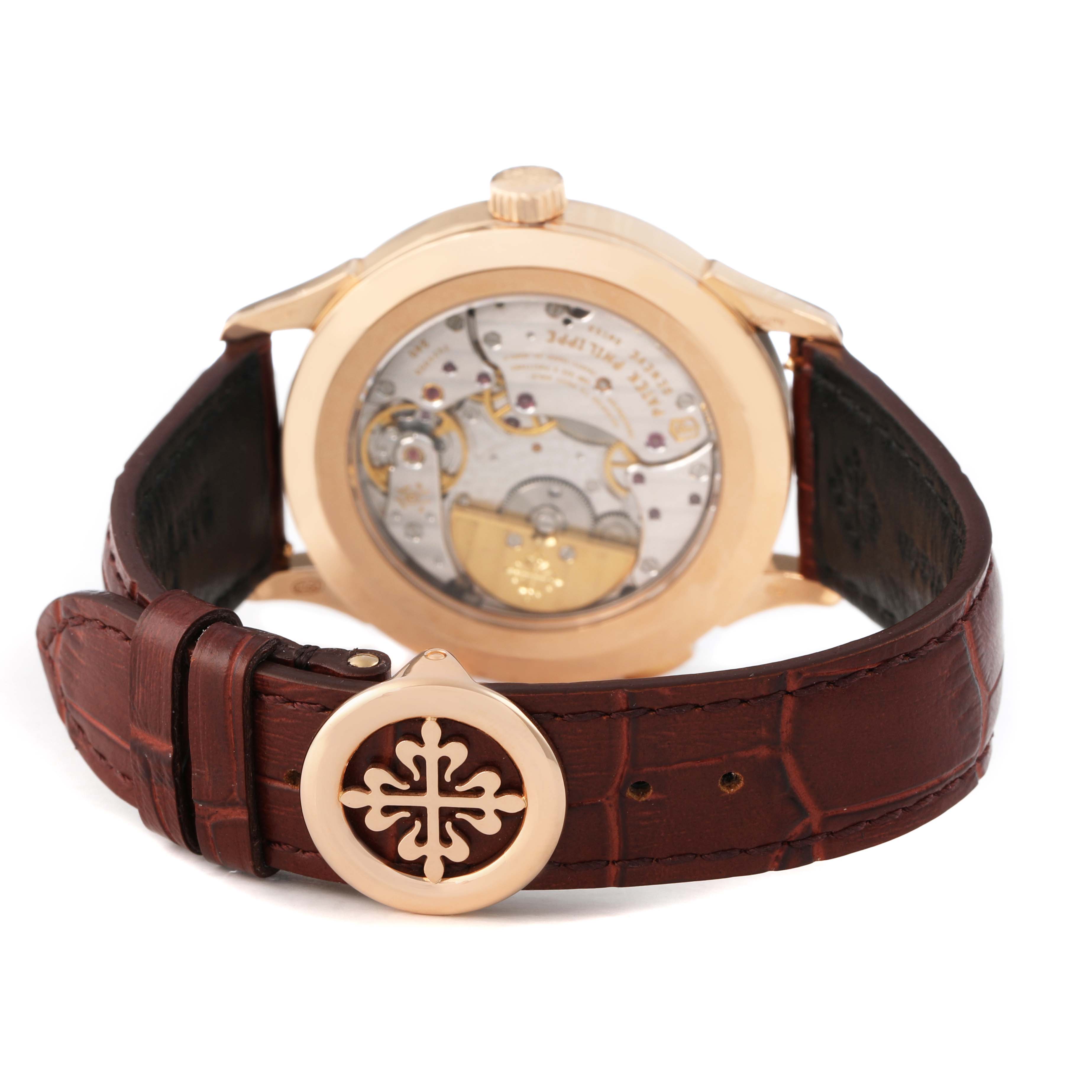 The Patek Philippe Complications 5230R-001 Men's Rose Gold Grey Dial watch is shown from the back, highlighting the movement and leather strap with logo buckle.