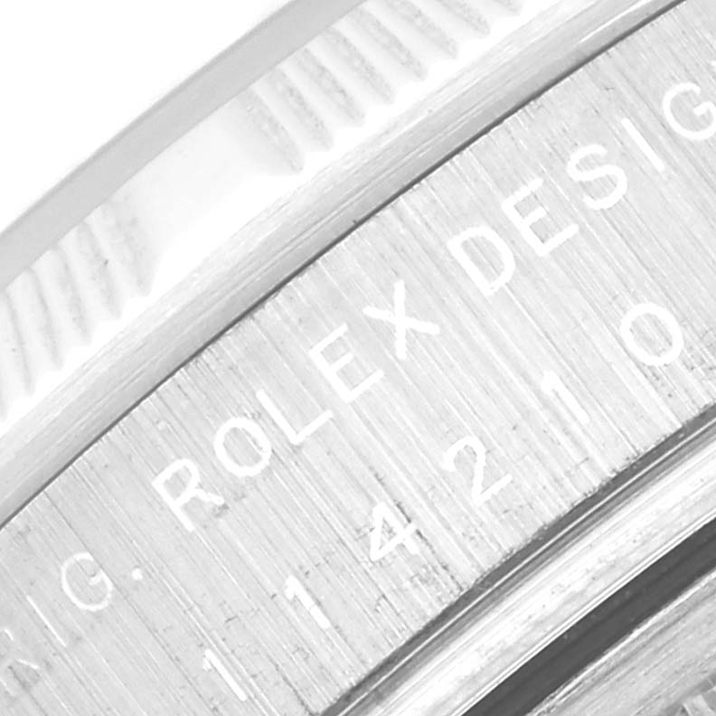 Close-up of the side of the Rolex Air-King 114210 Men's Stainless Steel Blue Dial 114210 Men's Stainless Steel Blue Dial watch, showing part of the bezel and engraved text.