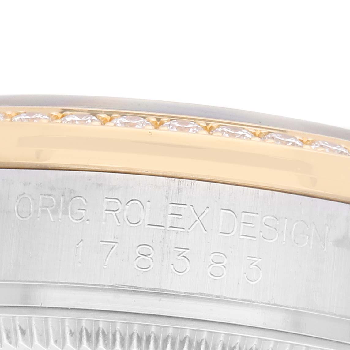 The image shows a close-up of the side of a Rolex Datejust 178383 Women's Steel and Gold (two tone) Silver Dial 178383 Women's Steel and Gold (two tone) Silver Dial, focusing on the engraved bezel with diamond accents.