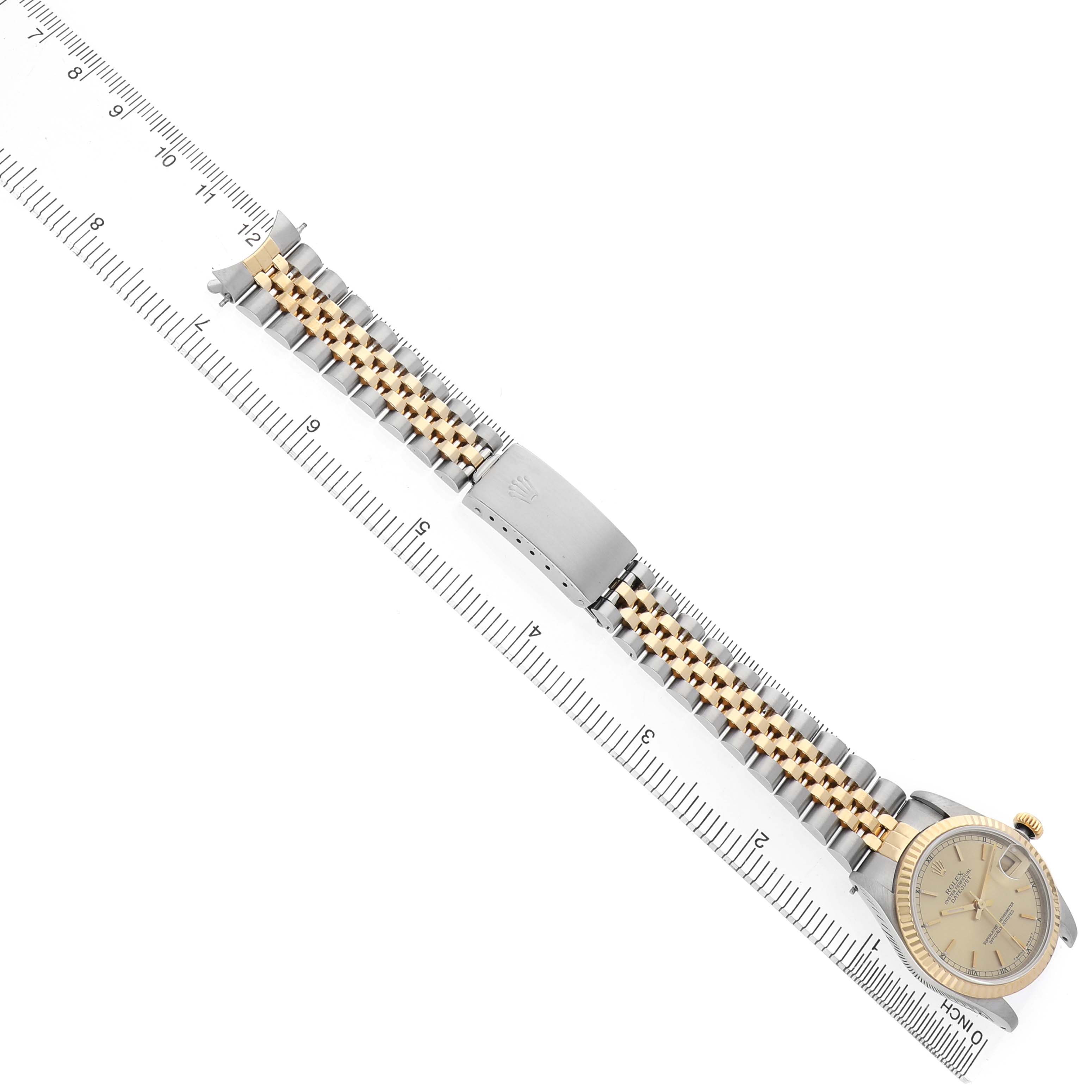 The image shows a Rolex Mid-Size 68273 Women's Steel and Gold (two tone) Champagne Dial watch, laid flat with its bracelet extended, alongside a ruler for scale.