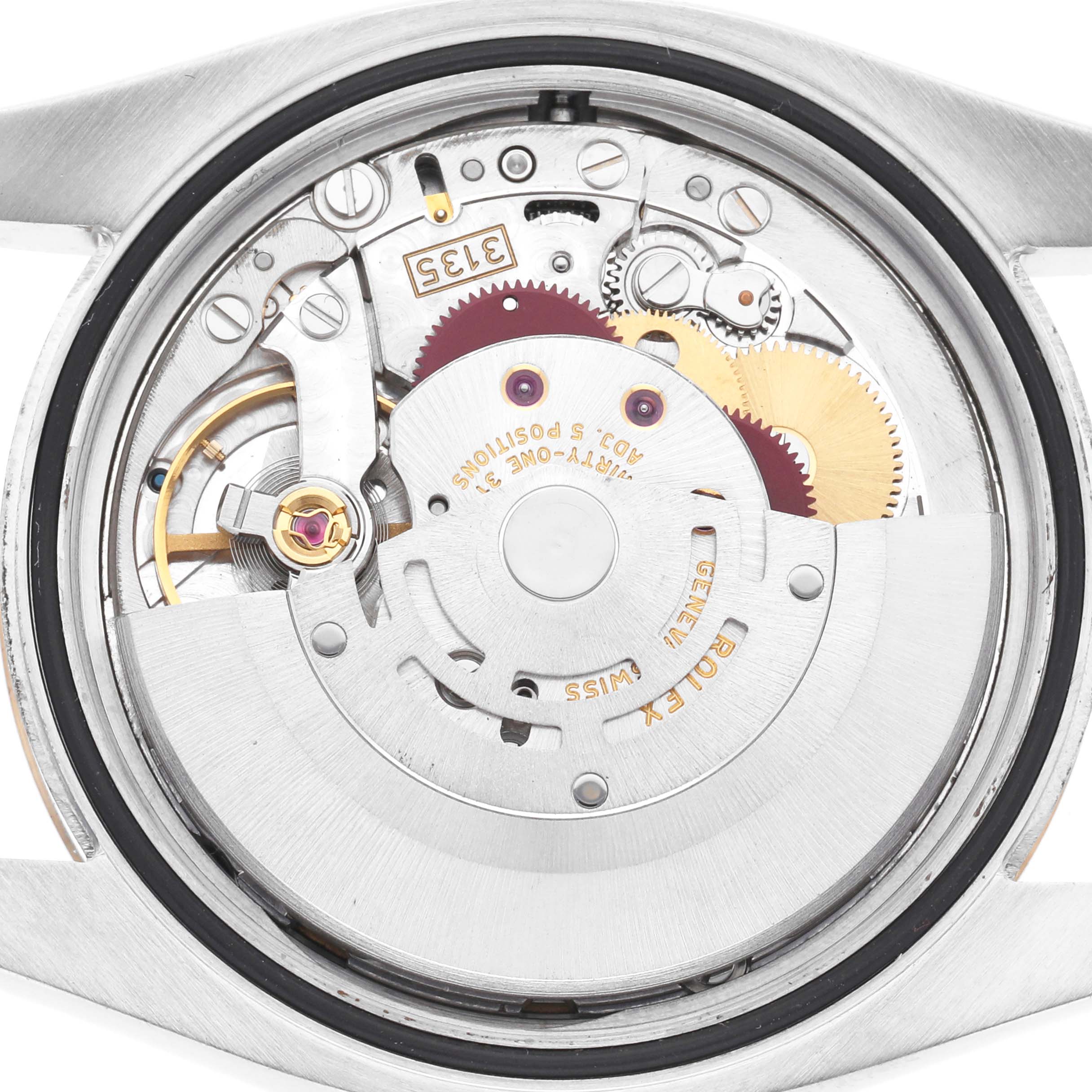 The image shows the back of a Rolex Datejust 116231 Men's Steel and Gold (two tone) Black Dial 116231 Men's Steel and Gold (two tone) Black Dial, highlighting its exposed internal movement and mechanical components.