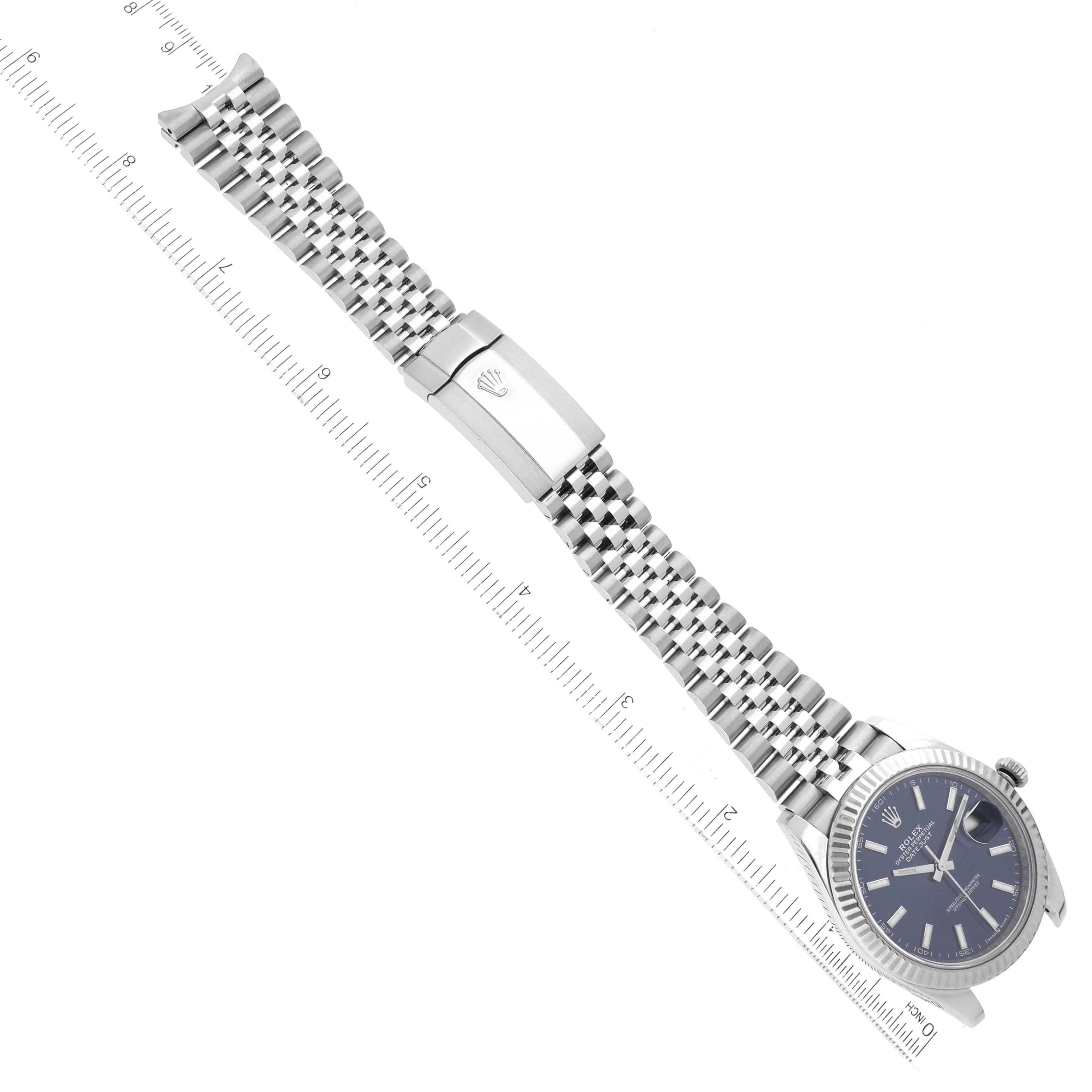 The image shows an overhead view of a Rolex Datejust 41 126334 Men
s Stainless Steel Blue Dial 126334 Men
s Stainless Steel Blue Dial watch, highlighting the face, bracelet, and clasp with an adjacent ruler.