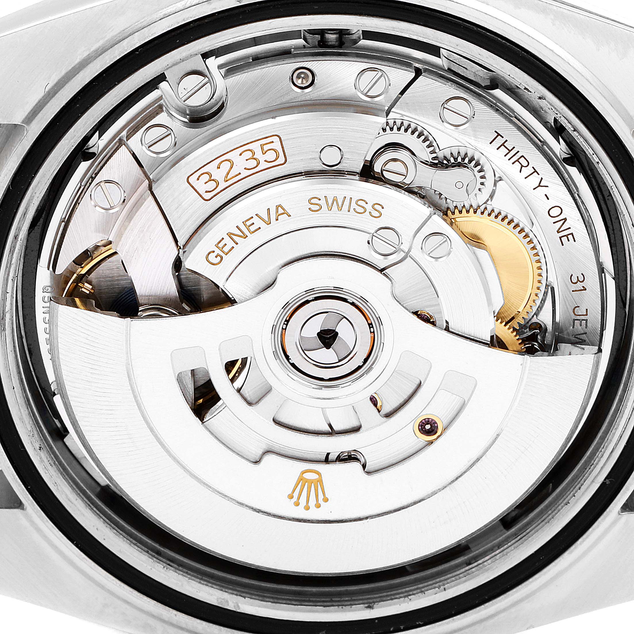 The image shows a close-up view of the movement inside a Rolex Datejust 41 126303 Men's Steel and Gold (two tone) Black Dial 126303 Men's Steel and Gold (two tone) Black Dial watch, focusing on the rotor and internal mechanics.