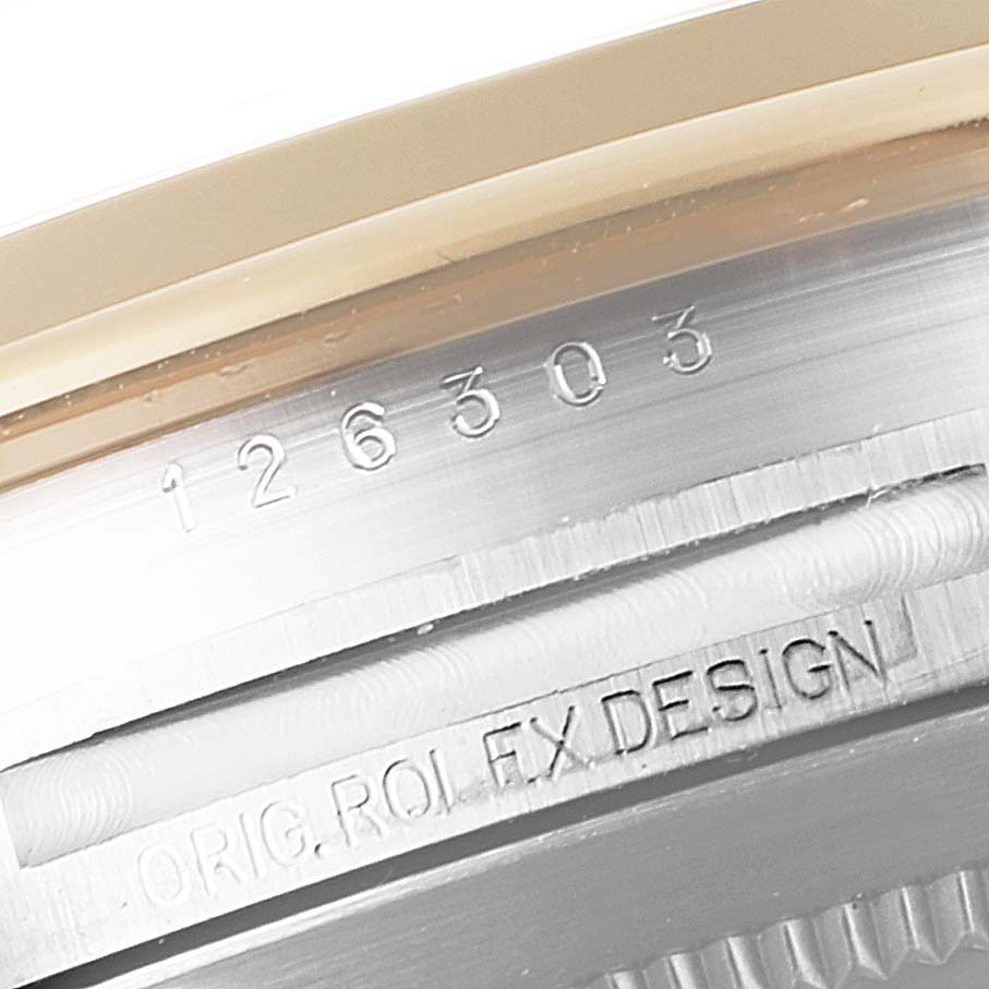The image shows a close-up of the serial and design numbers engraved on the caseback of the Rolex Datejust 41 126303 Men's Steel and Gold (two tone) Black Dial 126303 Men's Steel and Gold (two tone) Black Dial model.