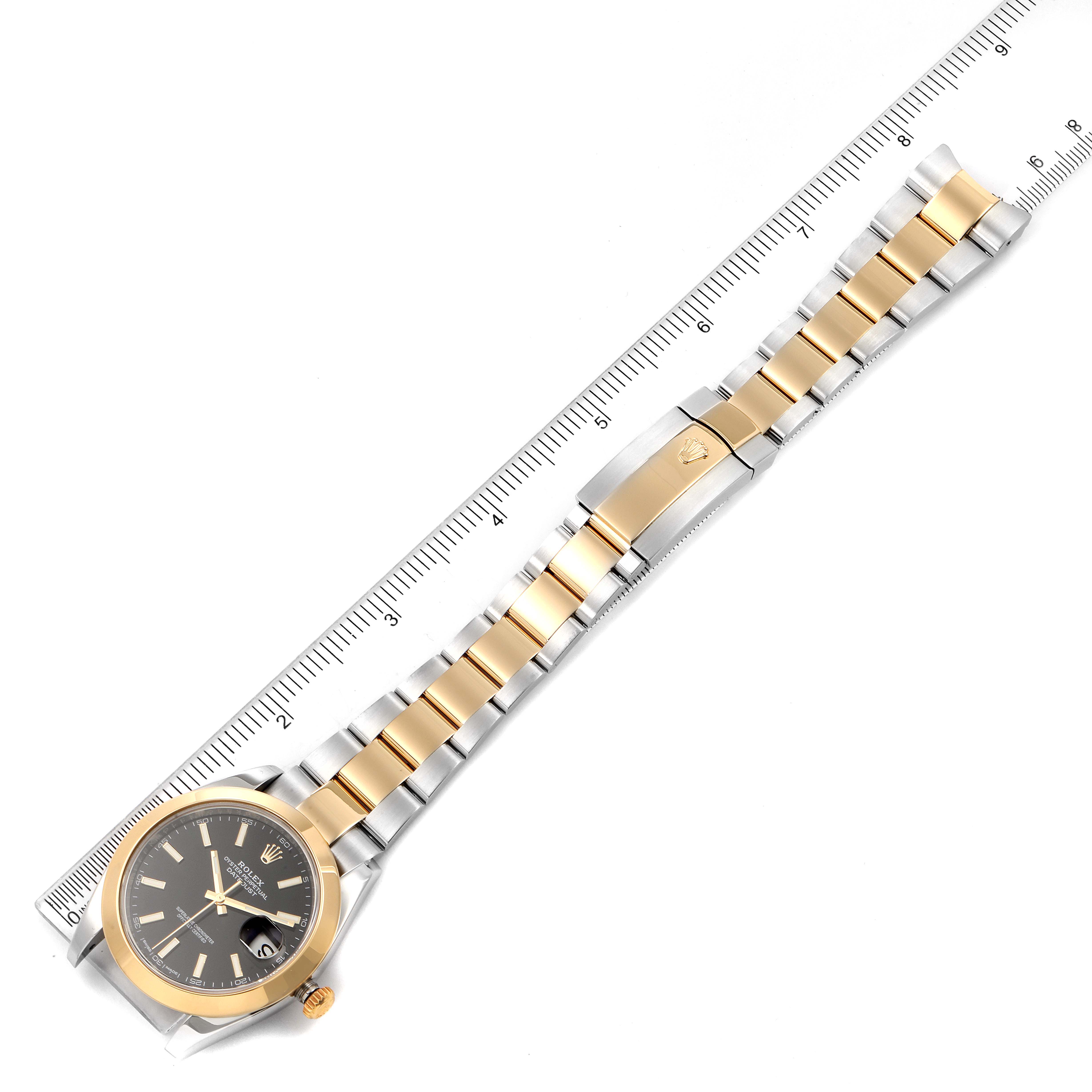 The image shows a Rolex Datejust 41 126303 Men's Steel and Gold (two tone) Black Dial 126303 Men's Steel and Gold (two tone) Black Dial watch, displayed flat with its bracelet and placed beside a ruler.
