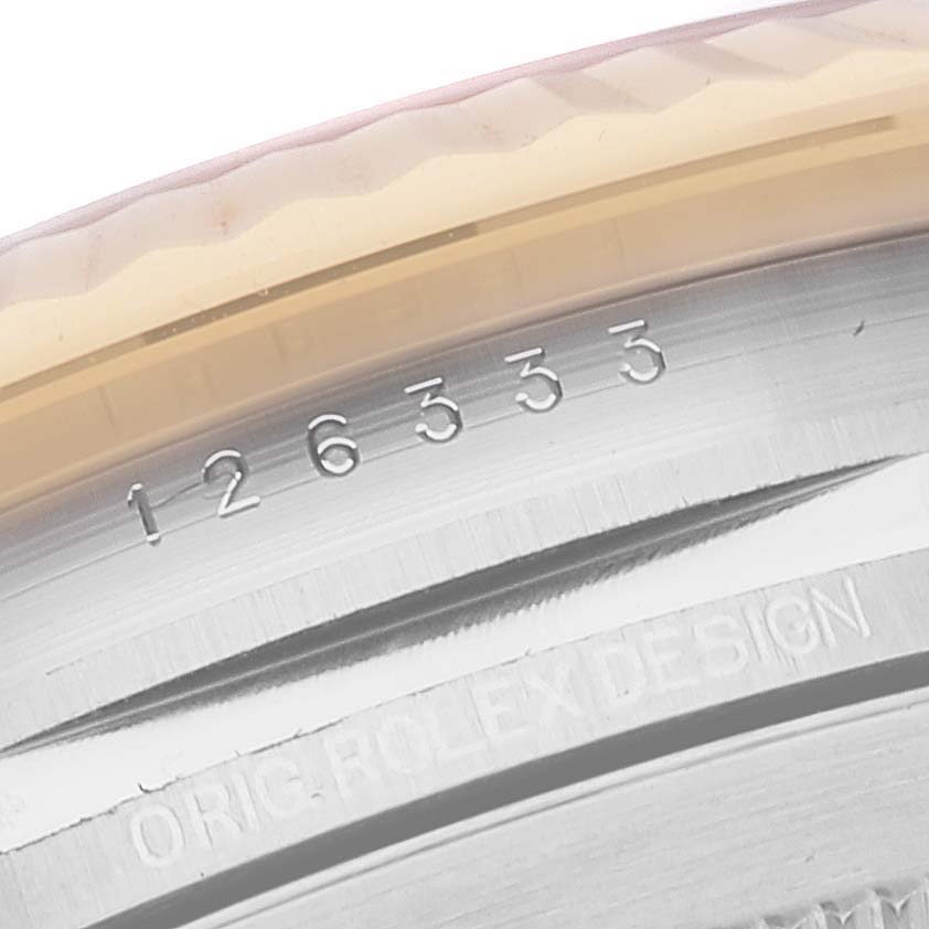 The image shows a close-up of the Datejust 41 model by Rolex, focusing on the bezel and engraved serial number.