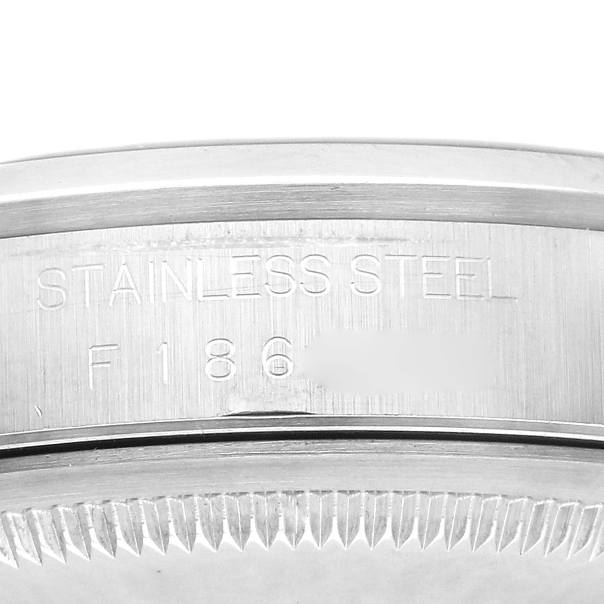 The image shows a close-up of the side of the Rolex Datejust 16200 Men's Stainless Steel Blue Dial 16200 Men's Stainless Steel Blue Dial, featuring stainless steel engraving and a serrated bezel edge.