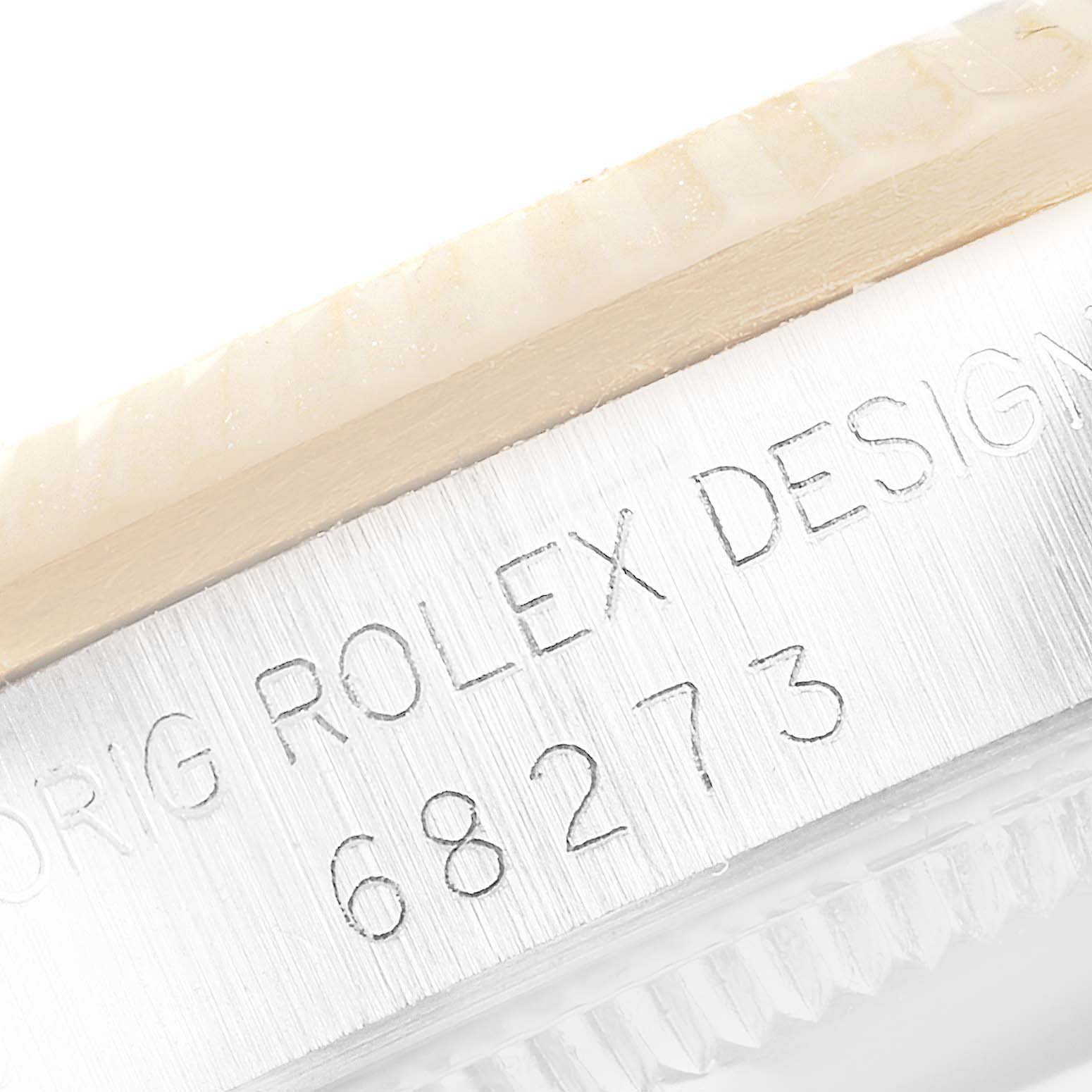 The image shows a close-up of the engraved bezel and case edge of a Rolex Mid-Size 68273 Women
s Steel and Gold (two tone) Black Dial 68273 Women
s Steel and Gold (two tone) Black Dial model, with model number 68273 visible.