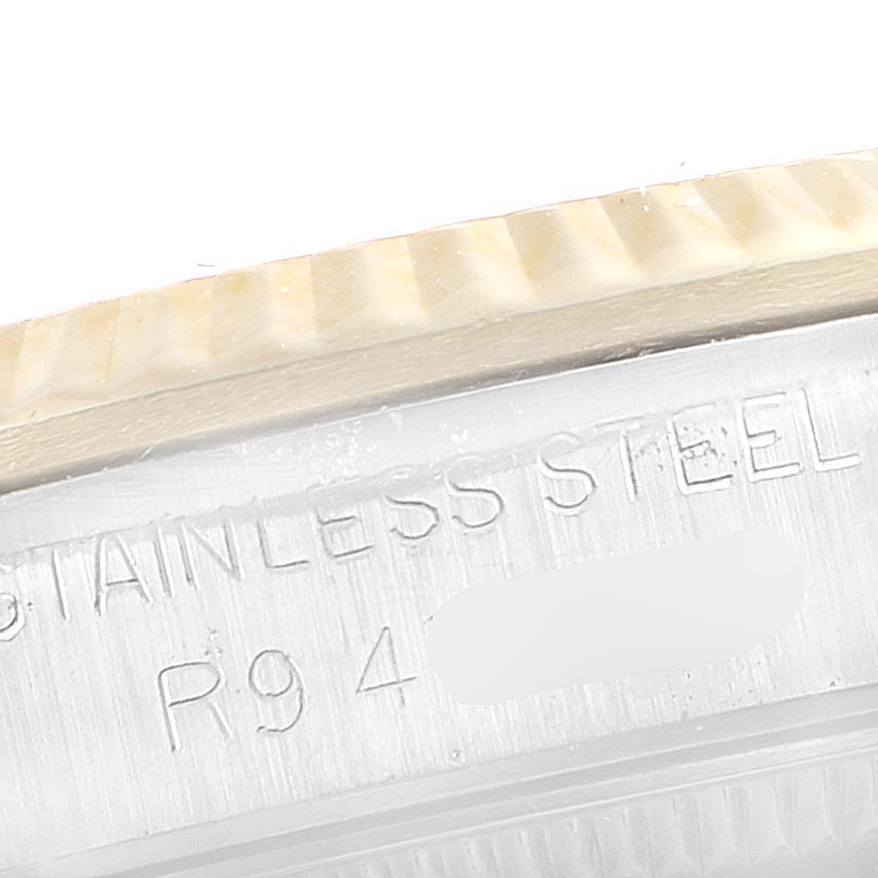 This close-up image shows the stainless steel bezel and case of a Rolex Mid-Size 68273 Women's Steel and Gold (two tone) Champagne Dial 68273 Women's Steel and Gold (two tone) Champagne Dial model watch.