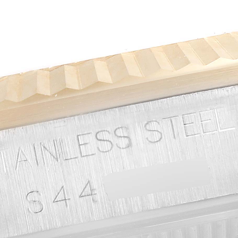 A close-up image of the stainless steel casing and bezel of a Rolex Mid-Size 68273 Women's Steel and Gold (two tone) Champagne Dial 68273 Women's Steel and Gold (two tone) Champagne Dial watch, showing partial engravings.