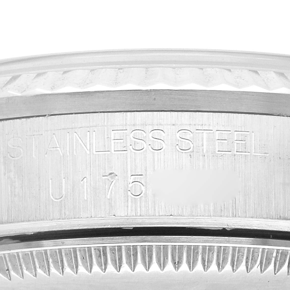 This image shows a close-up of the case side of a Rolex Mid-Size 68274 Women
s Stainless Steel White Dial 68274 Women
s Stainless Steel White Dial watch, focusing on the "Stainless Steel" engraving.