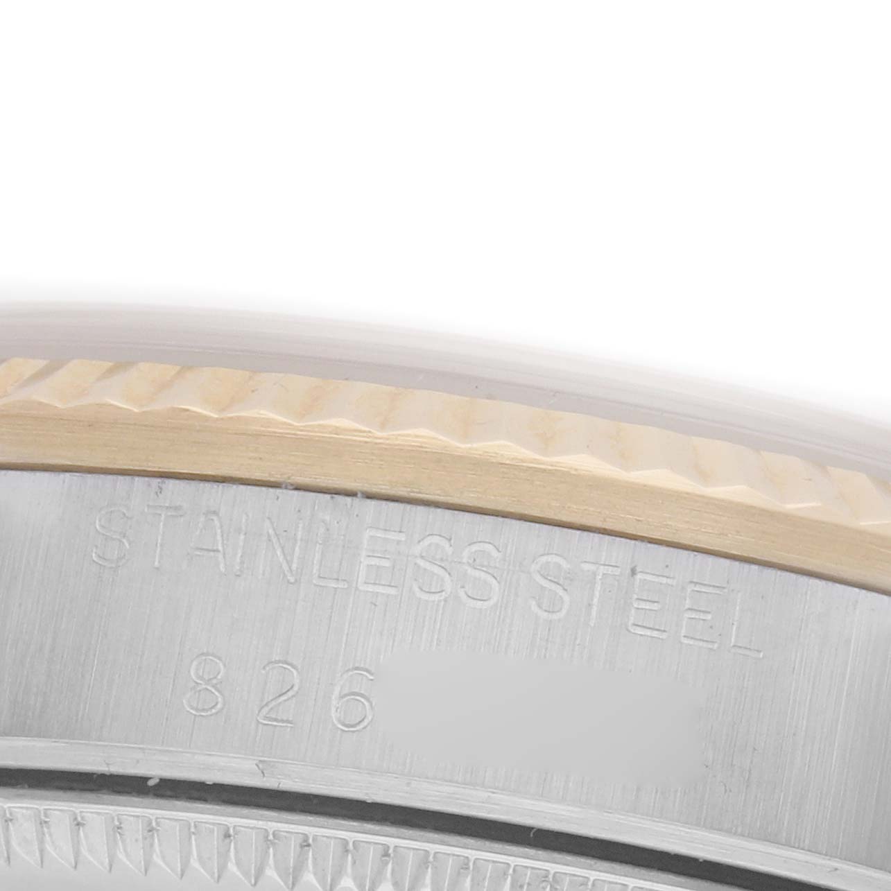 The image shows a close-up of the Rolex Mid-Size 68273 Women's Steel and Gold (two tone) Champagne Dial 68273 Women's Steel and Gold (two tone) Champagne Dial watch's stainless steel case side, featuring engraved markings.