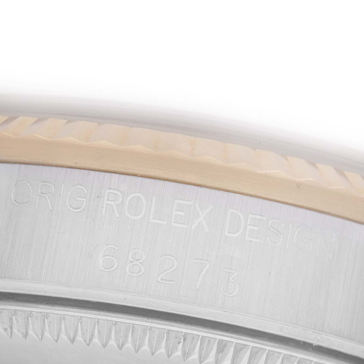 The image shows a close-up of the side of a Rolex Mid-Size 68273 Women's Steel and Gold (two tone) Champagne Dial 68273 Women's Steel and Gold (two tone) Champagne Dial model, highlighting the engraved design number on the case.