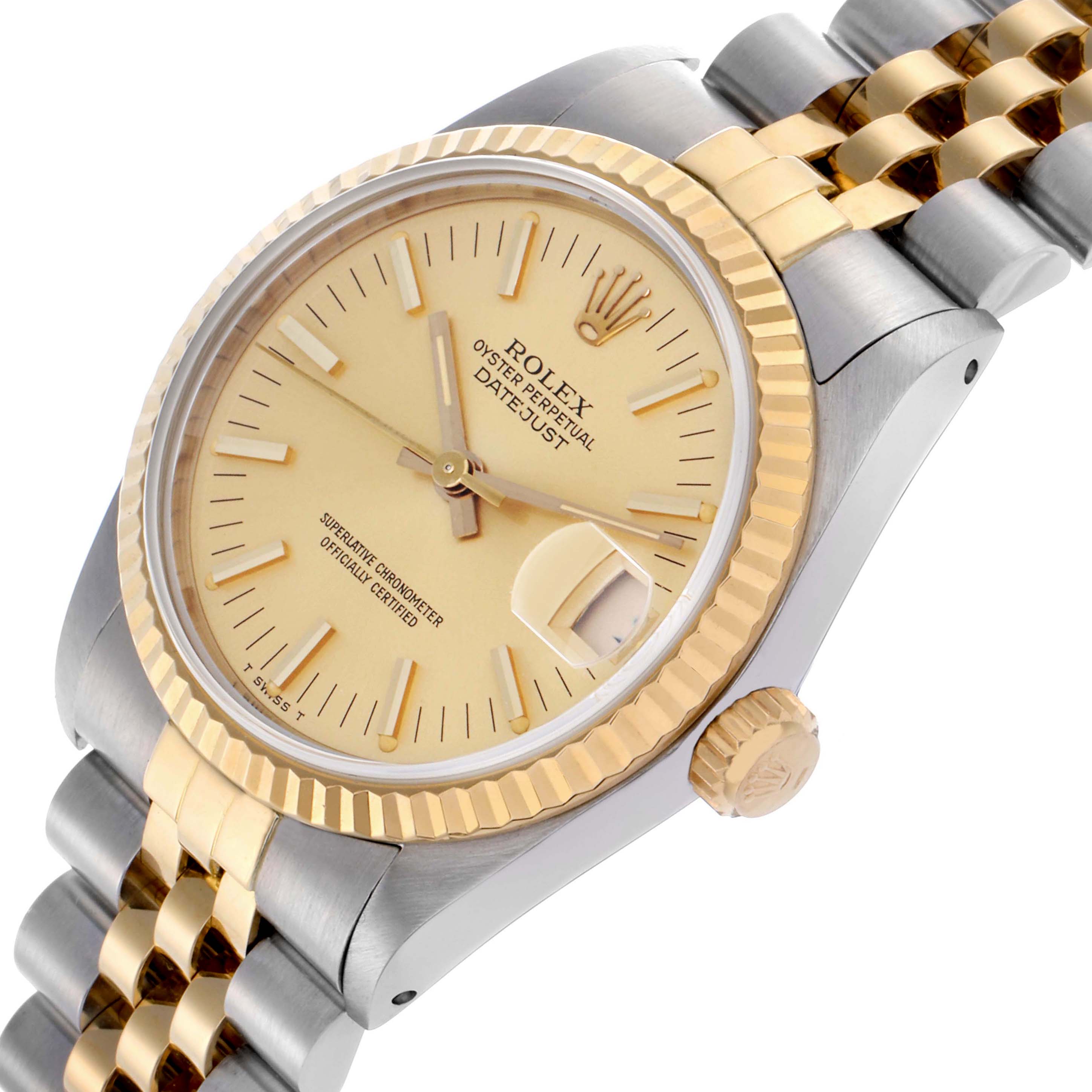 The Rolex Datejust Mid-Size watch is shown from a side angle, highlighting its gold bezel, crown, and two-tone bracelet.