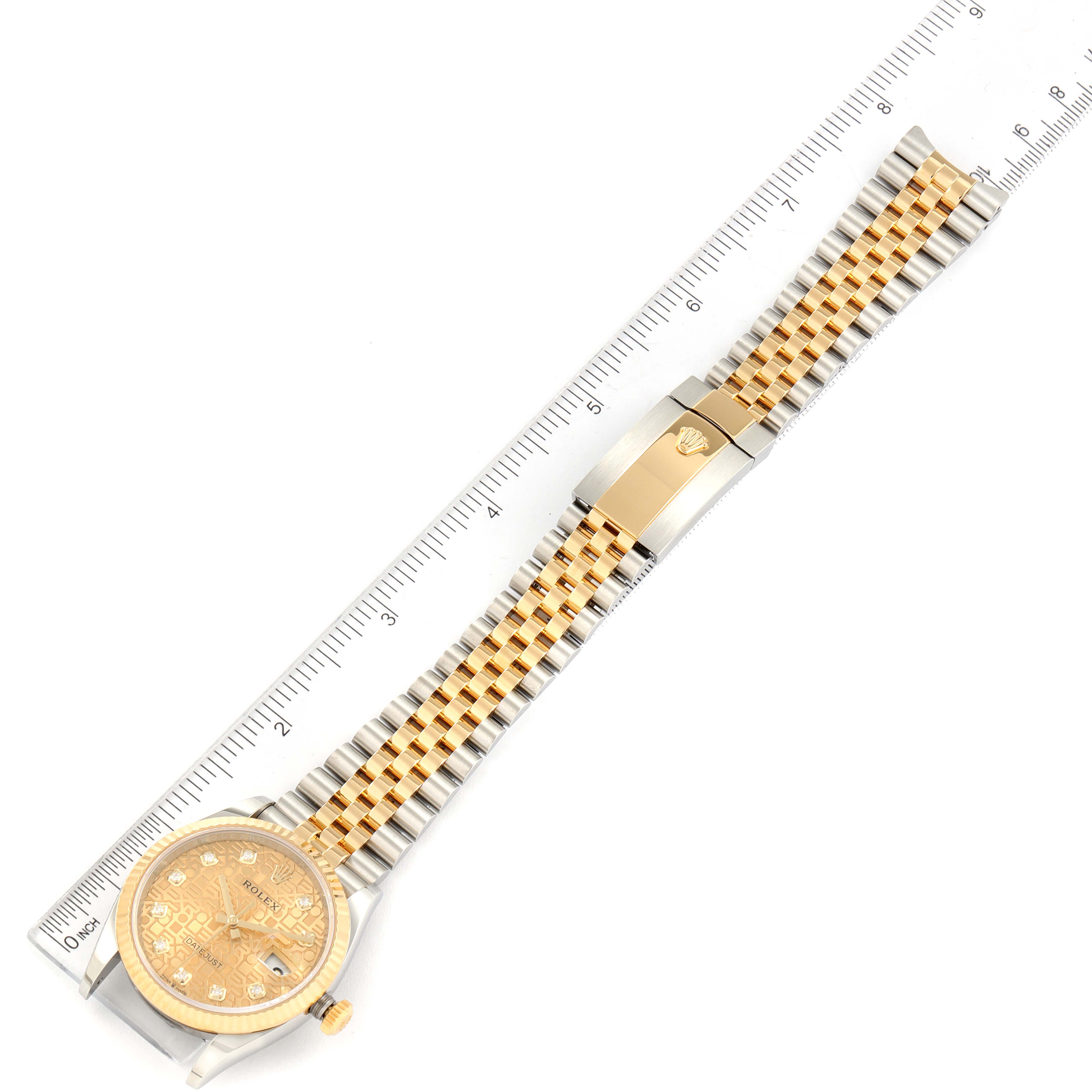 The image shows a top-down view of a Rolex Datejust 126233 Men's Steel and Gold (two tone) Champagne Dial 126233 Men's Steel and Gold (two tone) Champagne Dial watch with its full length extended alongside a ruler for scale.