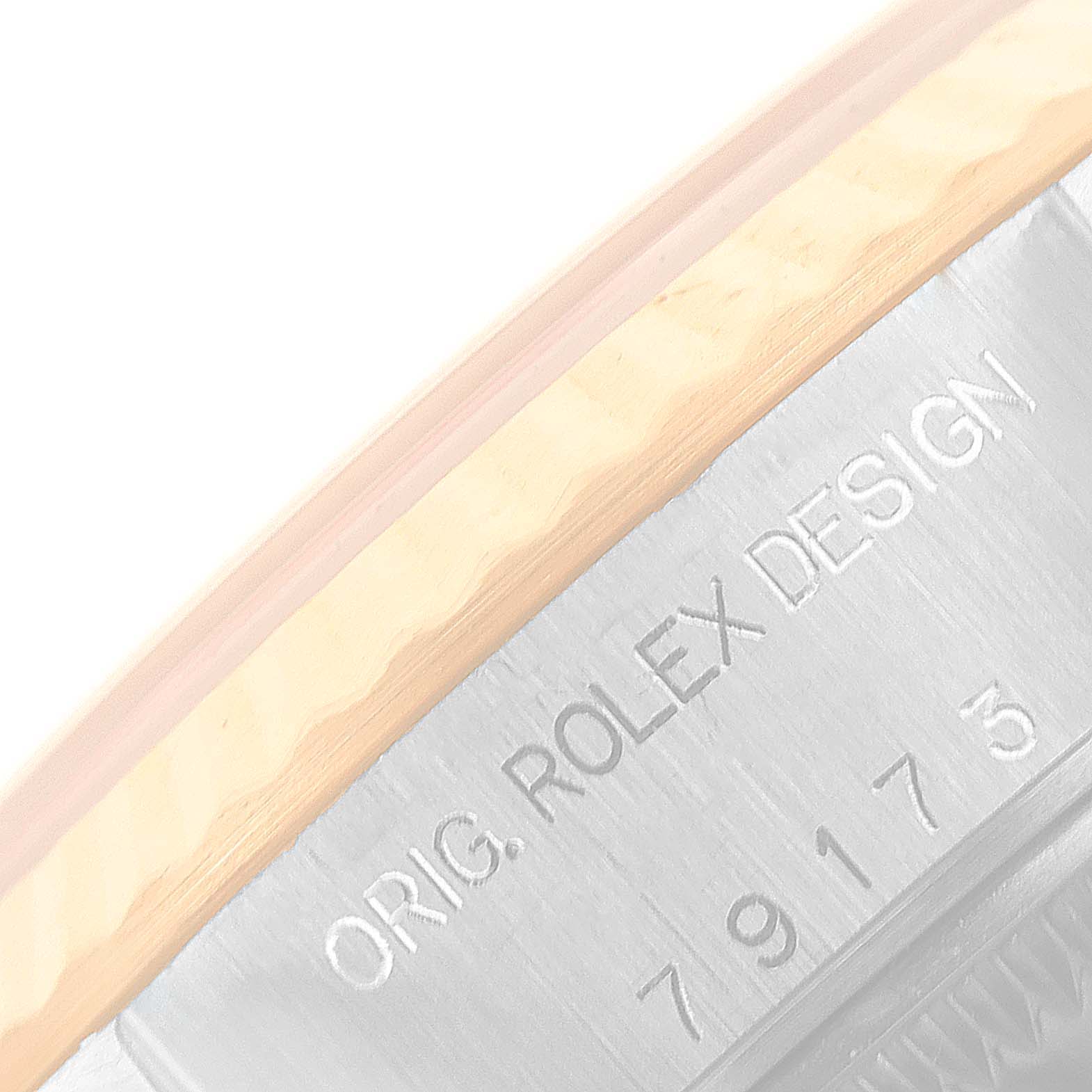 This image shows a close-up of the casing edge and serial number of a Rolex Datejust 79173 Women's Steel and Gold (two tone) Mother of Pearl Dial 79173 Women's Steel and Gold (two tone) Mother of Pearl Dial watch.