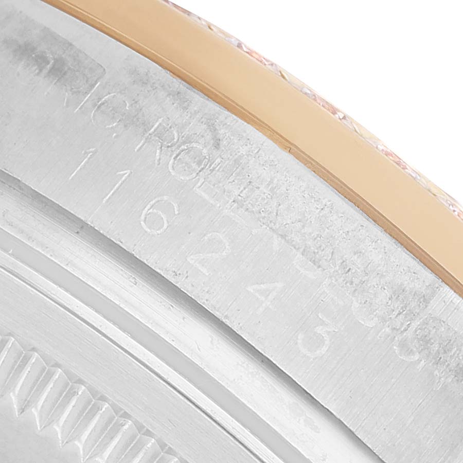 The image shows a close-up of the Rolex Datejust 116243 Men's Steel and Gold (two tone) Mother of Pearl Dial model's engraved caseback edge, highlighting the serial number.