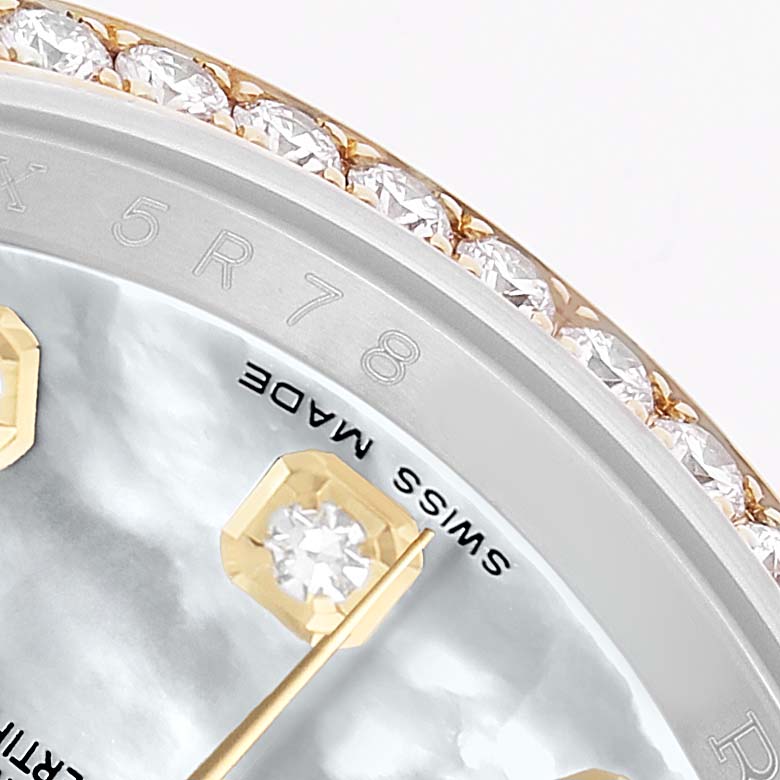 The close-up angle shows the Rolex Datejust 116243 Men's Steel and Gold (two tone) Mother of Pearl Dial's diamond-studded bezel, a segment of the dial, and a gold hour marker.