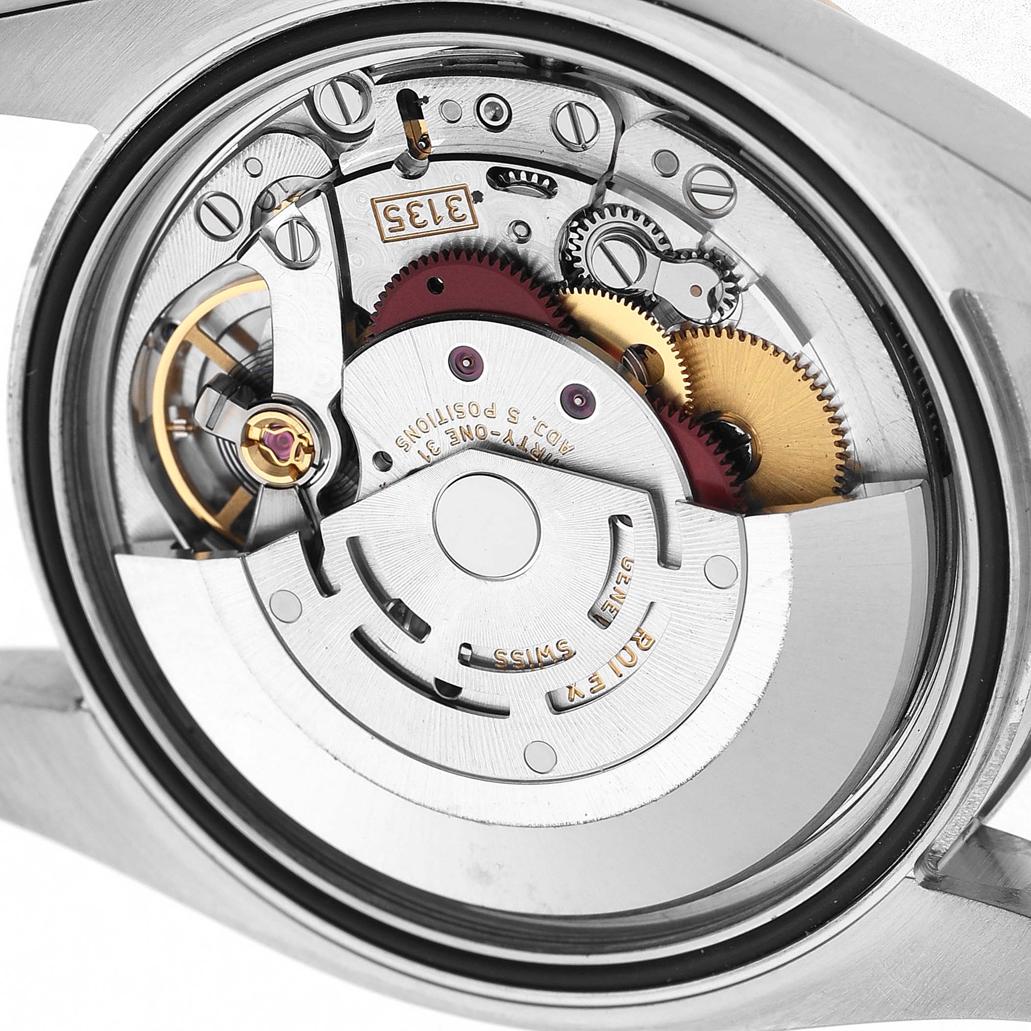 The image shows the movement of a Rolex Datejust 116243 Men's Steel and Gold (two tone) Mother of Pearl Dial watch from a back view, highlighting gears and rotor components.