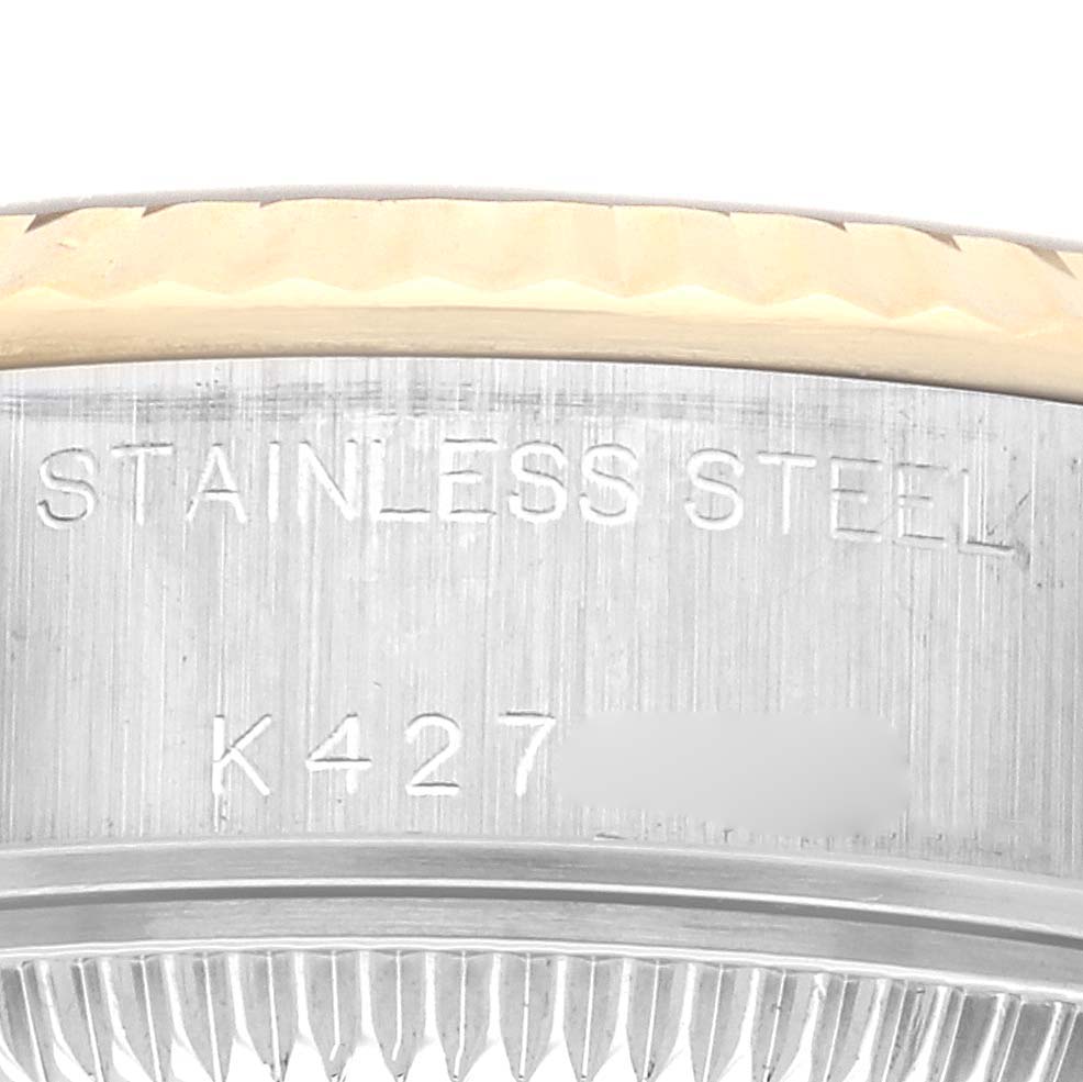 The image shows a close-up of the Rolex Datejust 79173 Women's Steel and Gold (two tone) Champagne Dial 79173 Women's Steel and Gold (two tone) Champagne Dial case back with "STAINLESS STEEL" and part of the model number engraved.