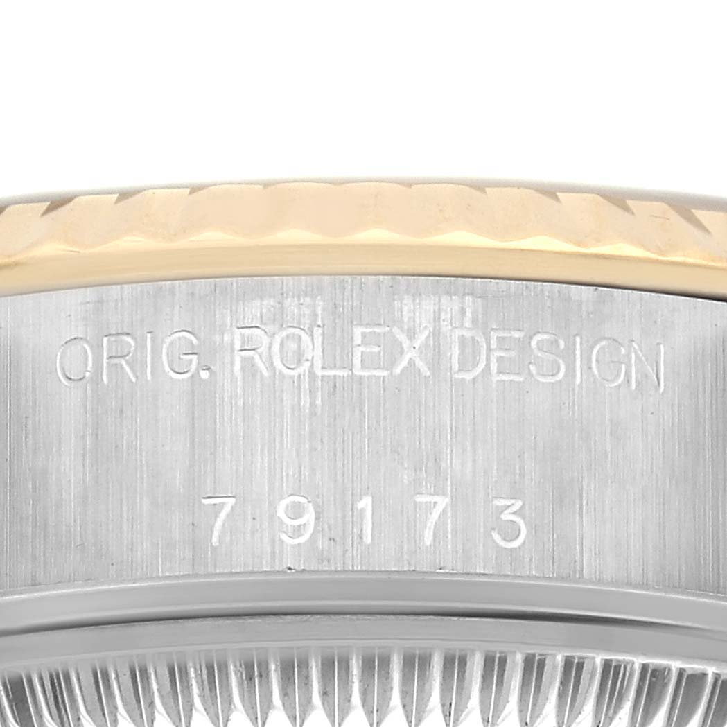 The image shows a close-up of the Rolex Datejust 79173 Women's Steel and Gold (two tone) Champagne Dial 79173 Women's Steel and Gold (two tone) Champagne Dial model's serial number and bezel edge.
