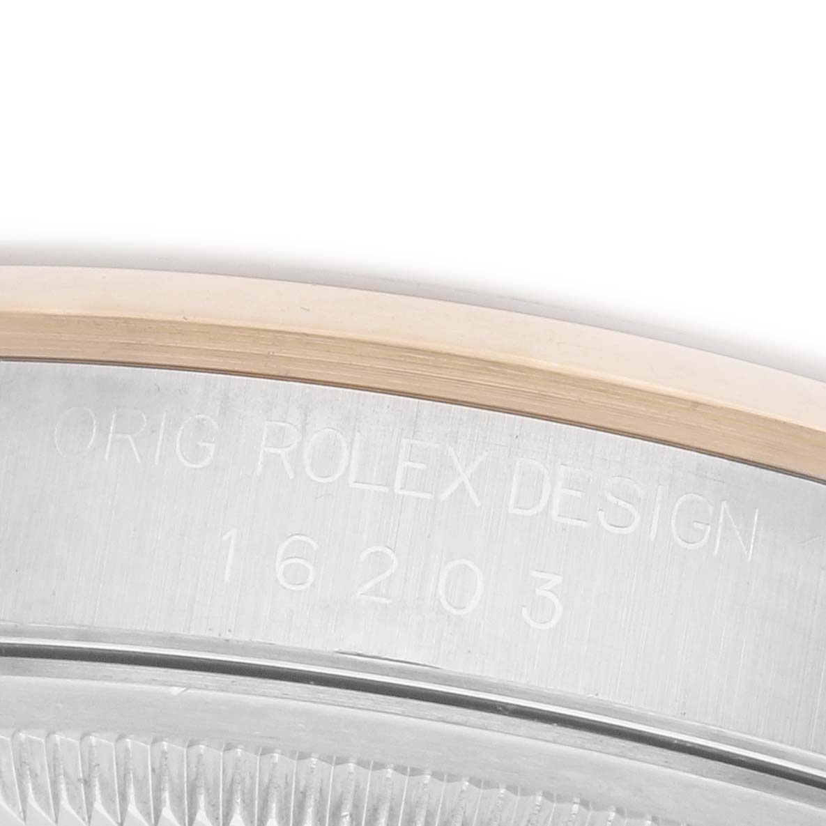 The image shows a detailed close-up of the Rolex Datejust 16203 Men's Steel and Gold (two tone) Grey Dial 16203 Men's Steel and Gold (two tone) Grey Dial model's case, highlighting the engraving and bezel edge.