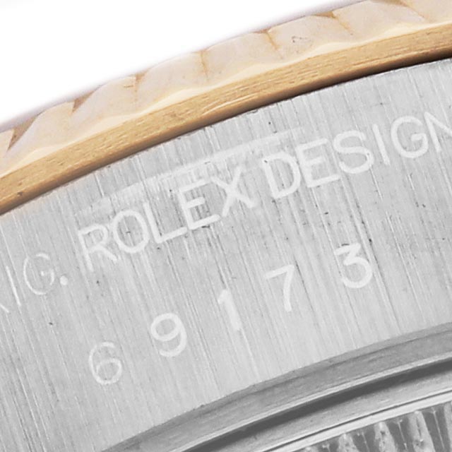 The image shows a close-up of the case side of a Rolex Datejust 69173 Women's Steel and Gold (two tone) White Dial 69173 Women's Steel and Gold (two tone) White Dial, highlighting the engraved model number and design details.