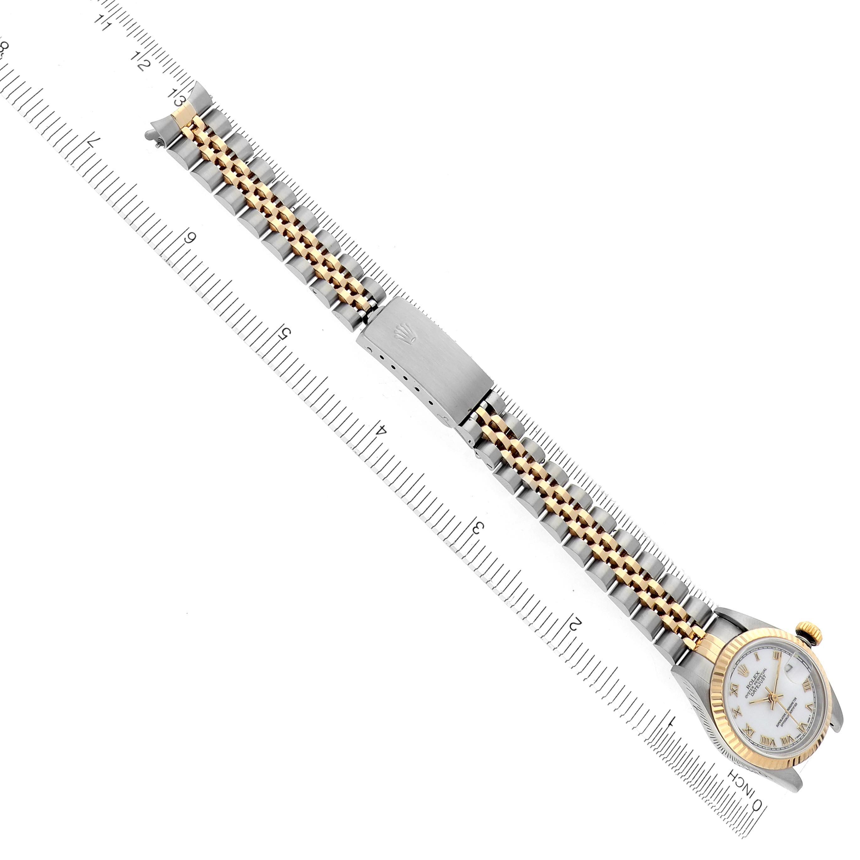 The image shows a Rolex Datejust 69173 Women's Steel and Gold (two tone) White Dial 69173 Women's Steel and Gold (two tone) White Dial watch laid flat with a focus on its bracelet and clasp alongside a ruler for length reference.