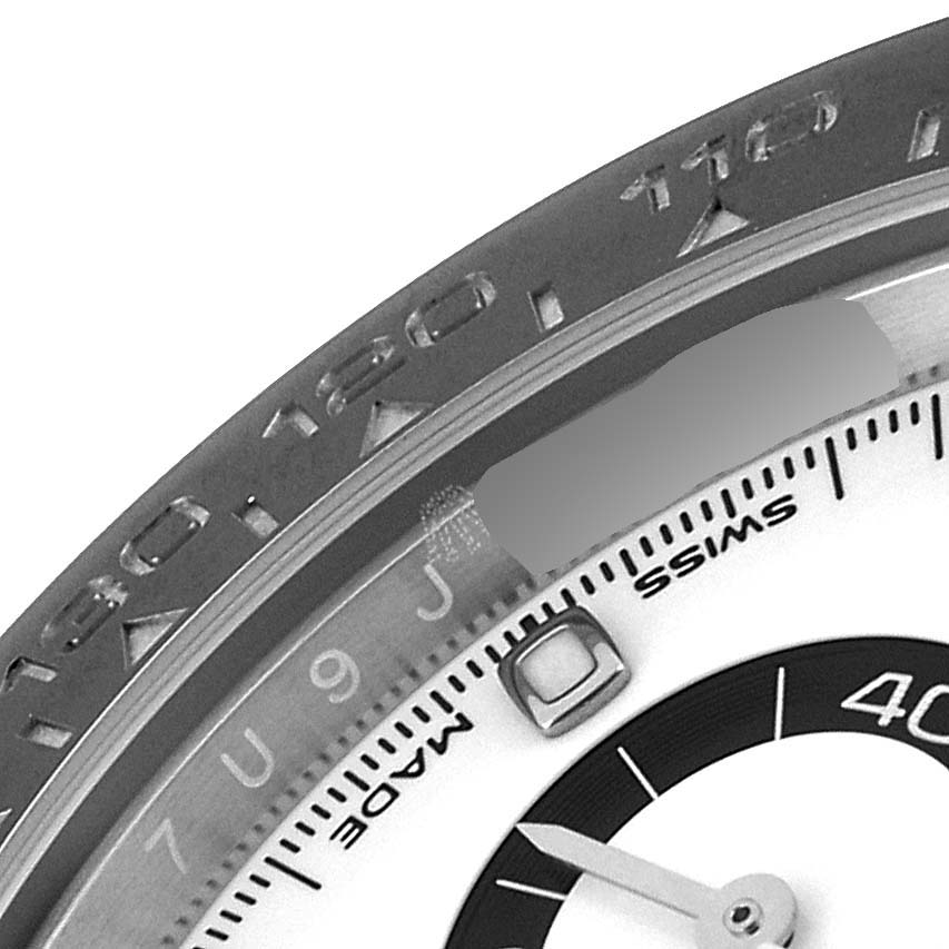 This image shows a close-up of the bezel and a portion of the dial of a Rolex Daytona 116500 Men
s Stainless Steel White Dial 116500 Men
s Stainless Steel White Dial watch.
