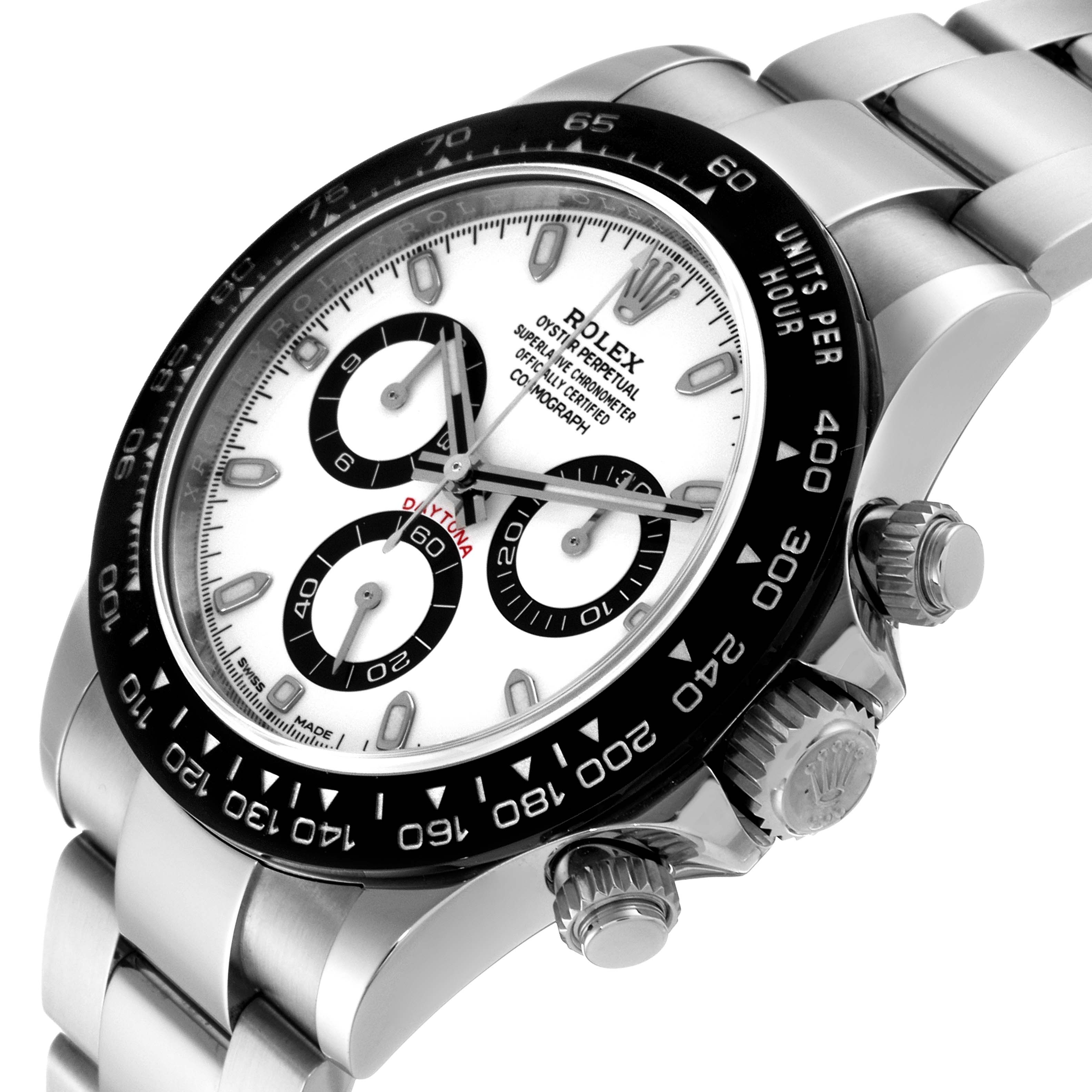 The image shows an angled view of the Rolex Daytona 116500 Men
s Stainless Steel White Dial 116500 Men
s Stainless Steel White Dial, highlighting the dial, bezel, and chronograph pushers.