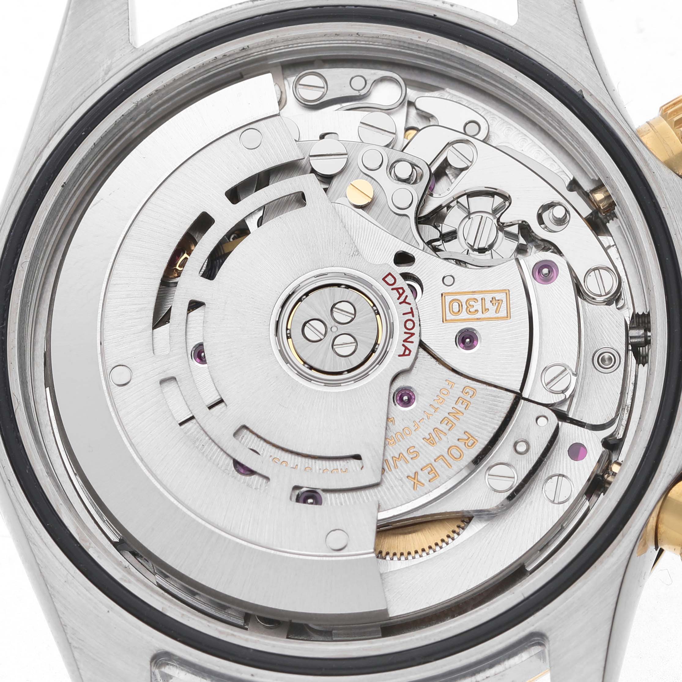 The image shows the movement of a Rolex Daytona 116503 Men's Steel and Gold (two tone) Blue Dial watch from the back, featuring gears and the rotor mechanism.