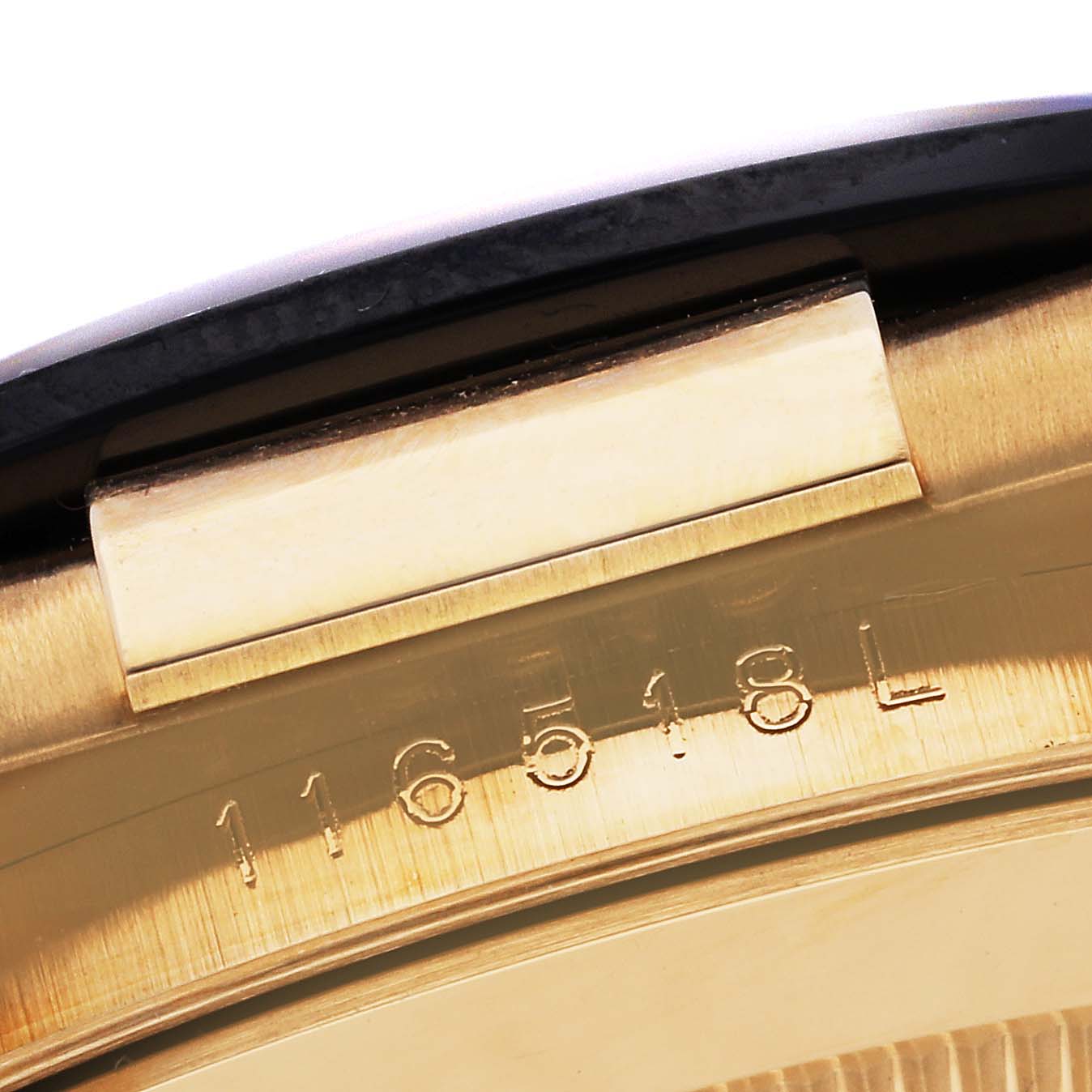 This close-up image shows the engraved model number "116518L" on the side of the Rolex Daytona 116518 Men's Yellow Gold Black Dial 116518 Men's Yellow Gold Black Dial watch casing.