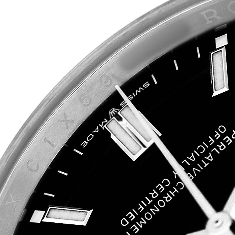 The image shows a close-up of the dial, hands, and a portion of the bezel of a Rolex Explorer 214270 Men's Stainless Steel Black Dial watch.