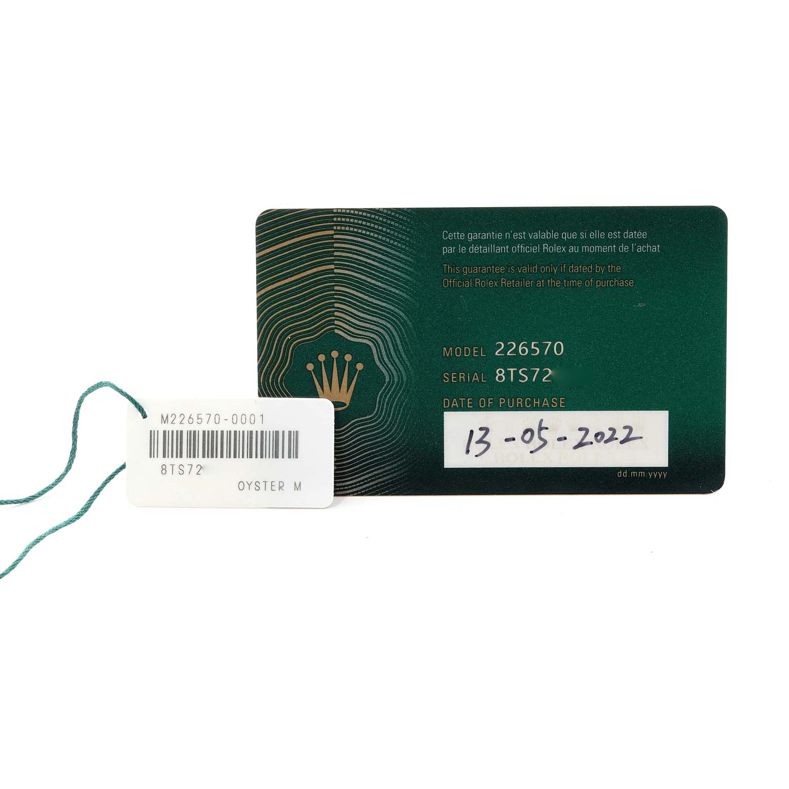 The image shows the warranty card and a tag with a serial number for a Rolex Explorer 226570 Men
s Stainless Steel White Dial 226570 Men
s Stainless Steel White Dial model 226570.