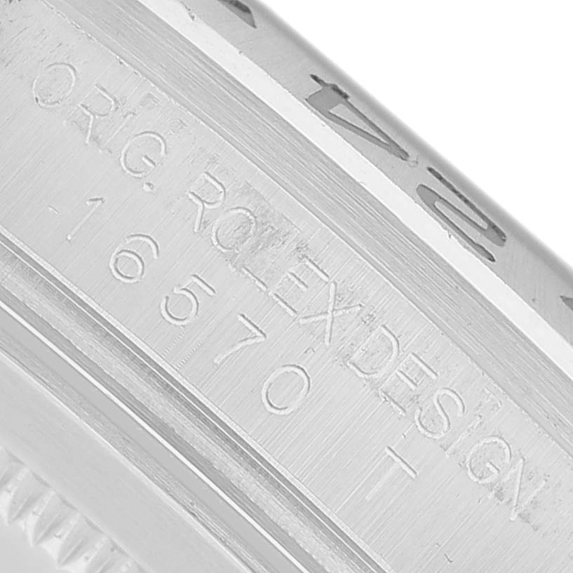 The image shows an angled close-up of the case side detailing the model number and design engraving on a Rolex Explorer 16570 Men's Stainless Steel Black Dial.