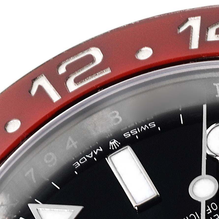 This close-up image shows the bezel and part of the dial of a Rolex GMT-Master 126710BLRO Men
s Stainless Steel Black Dial 126710BLRO Men
s Stainless Steel Black Dial watch.