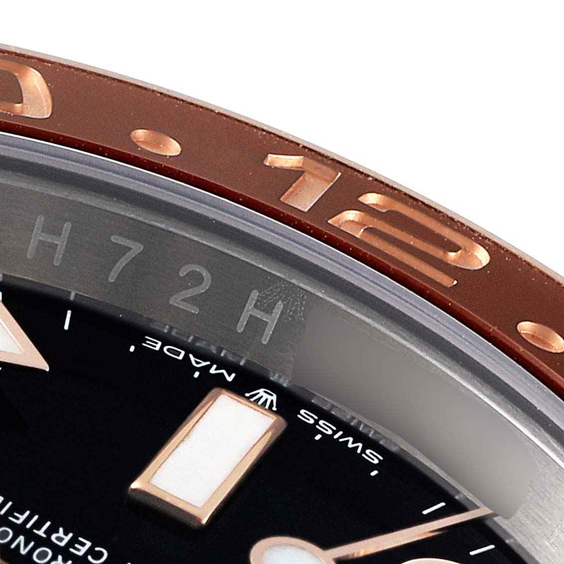 The close-up angle shows the bezel, part of the dial, and hour marker of a Rolex GMT-Master 126711CHNR Men's Steel and Gold (two tone) Black Dial 126711CHNR Men's Steel and Gold (two tone) Black Dial watch.