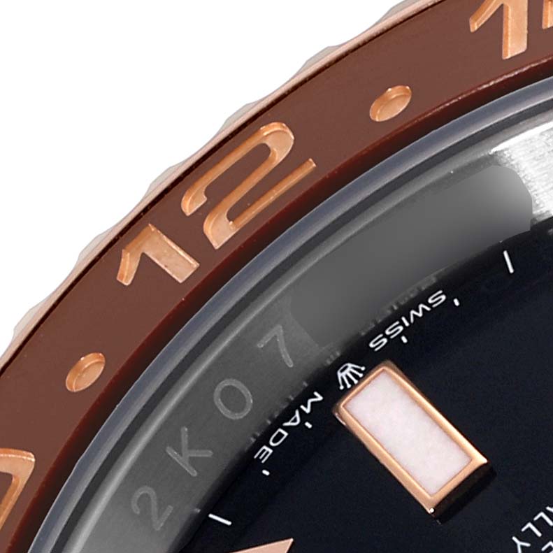 This close-up image captures the bezel, dial, and a portion of the hour marker of a Rolex GMT-Master 126711CHNR Men's Steel and Gold (two tone) Black Dial 126711CHNR Men's Steel and Gold (two tone) Black Dial watch.