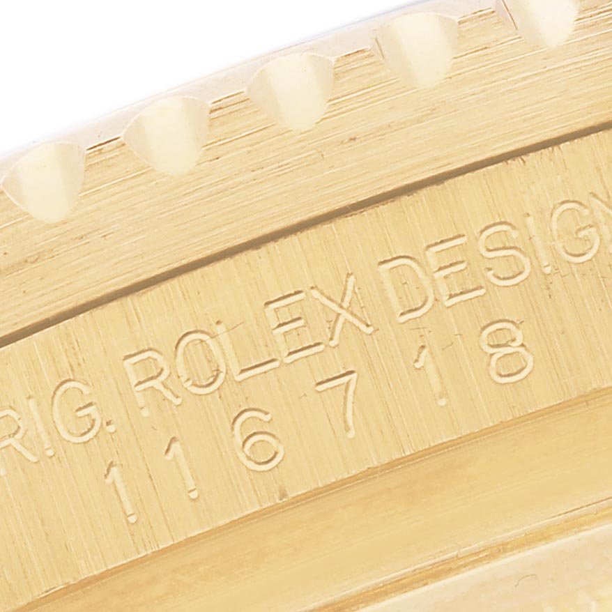 This close-up angle shows the side engraving on the bezel of a Rolex GMT-Master 116718 Men
s Yellow Gold Black Dial 116718 Men
s Yellow Gold Black Dial watch.