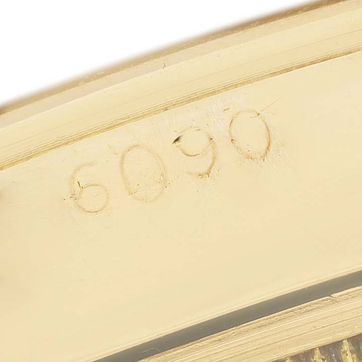 This image shows a close-up of the inner case engraving with the model number "6090" for a Rolex Oyster Perpetual 6085 Men's Yellow Gold Champagne Dial watch.