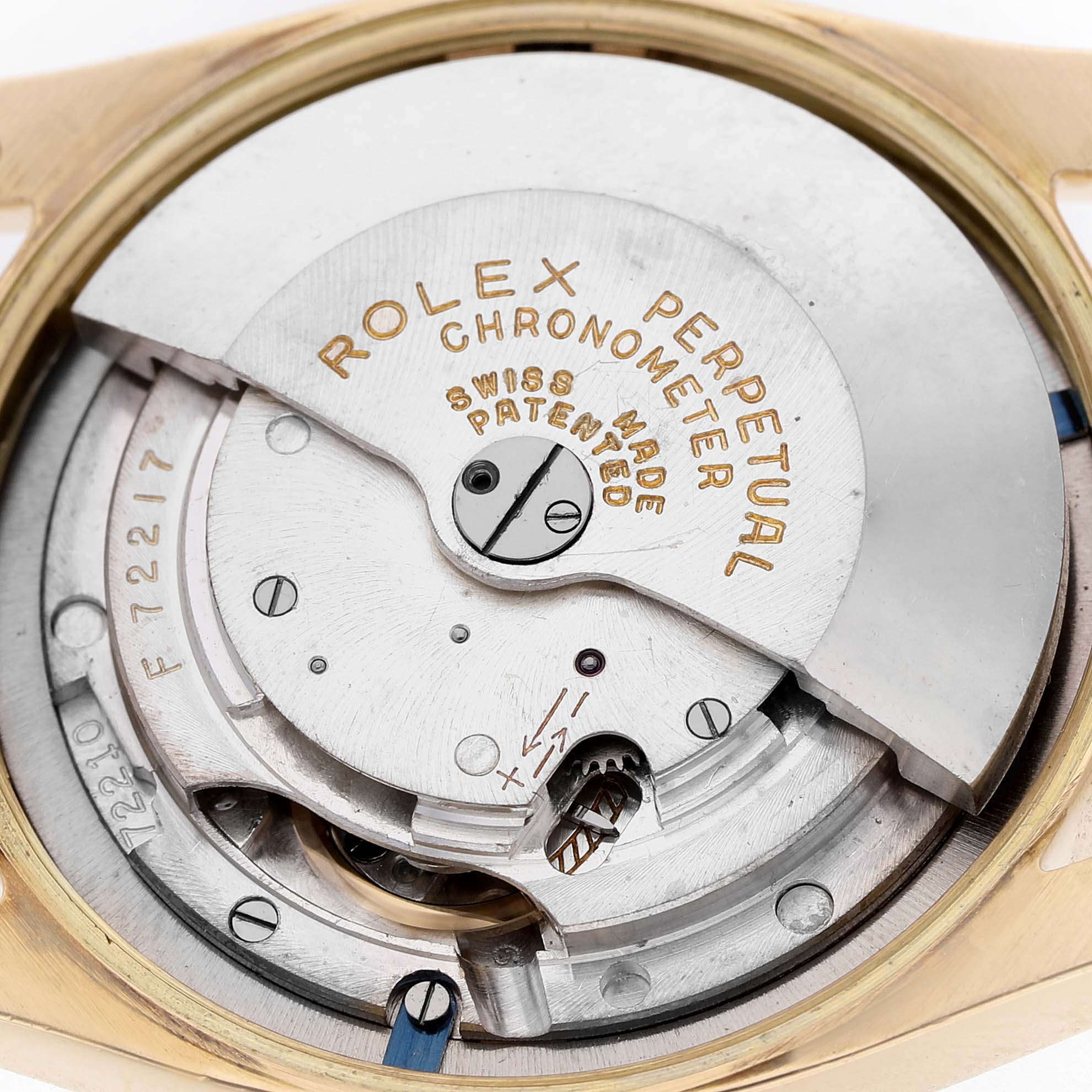 The image shows the movement of a Rolex Oyster Perpetual 6085 Men's Yellow Gold Champagne Dial watch from a top-down angle.