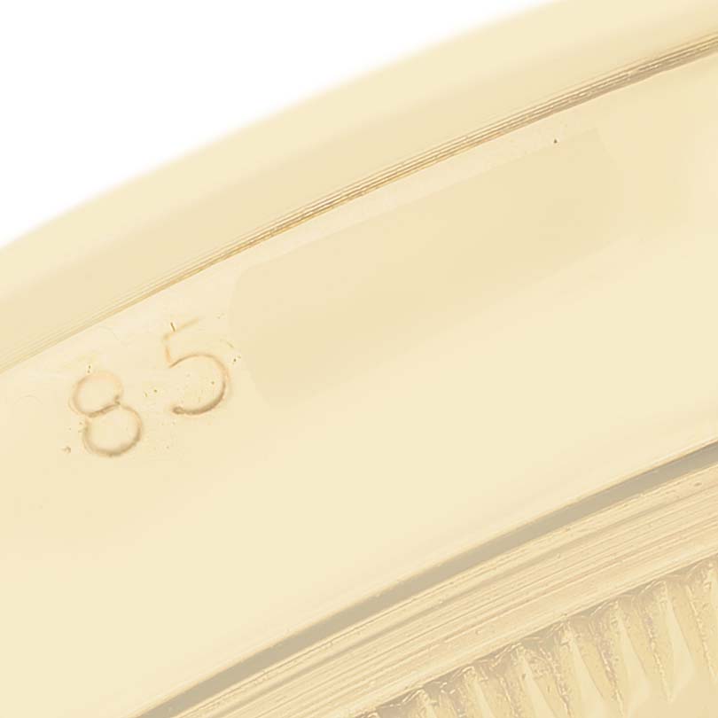 The image shows a close-up of the bezel and part of the case of a Rolex Oyster Perpetual 6085 Men's Yellow Gold Champagne Dial watch.