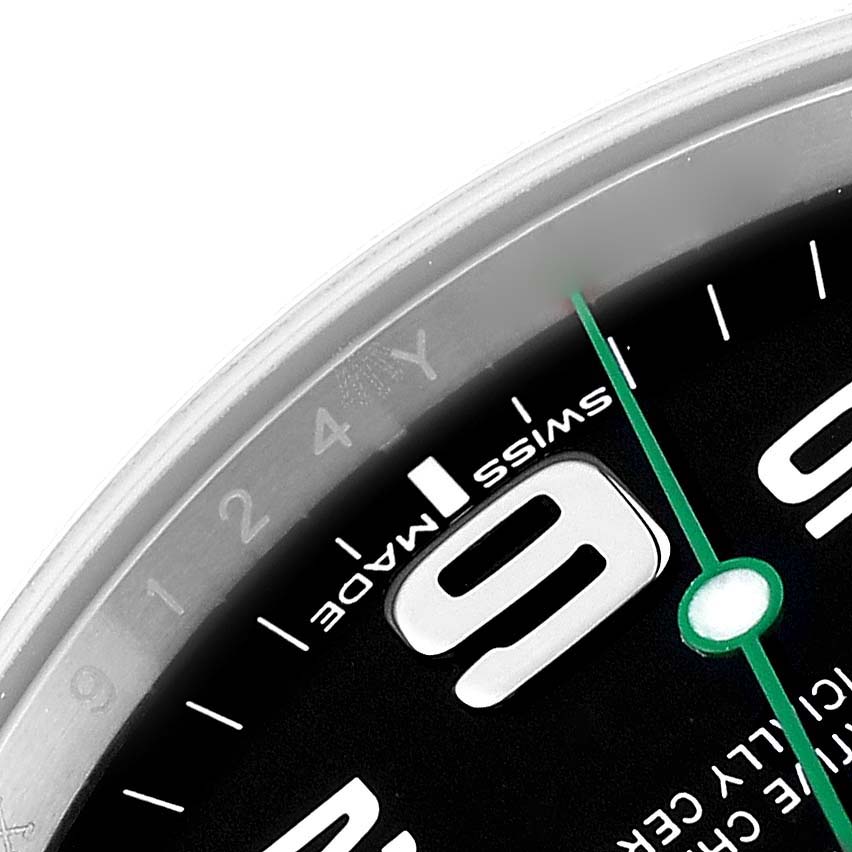 This close-up of the Rolex Air-King 116900 Men's Stainless Steel Black Dial 116900 Men's Stainless Steel Black Dial watch shows part of the dial, specifically the numeral 9 and the minute hand.