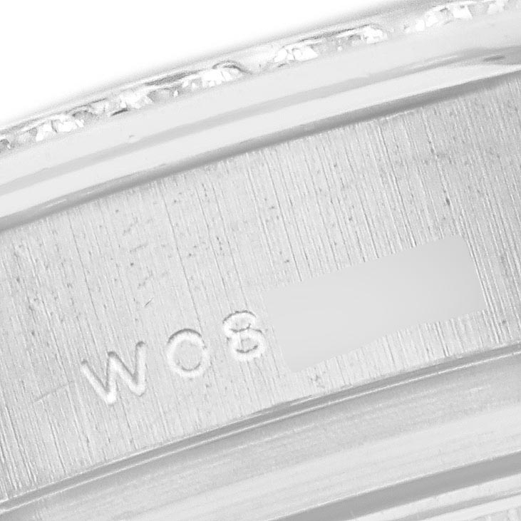 The image shows a close-up of the side engraving on the bezel or band of a Rolex Pearlmaster 69299 Women
s White Gold Mother of Pearl Dial 69299 Women
s White Gold Mother of Pearl Dial watch.
