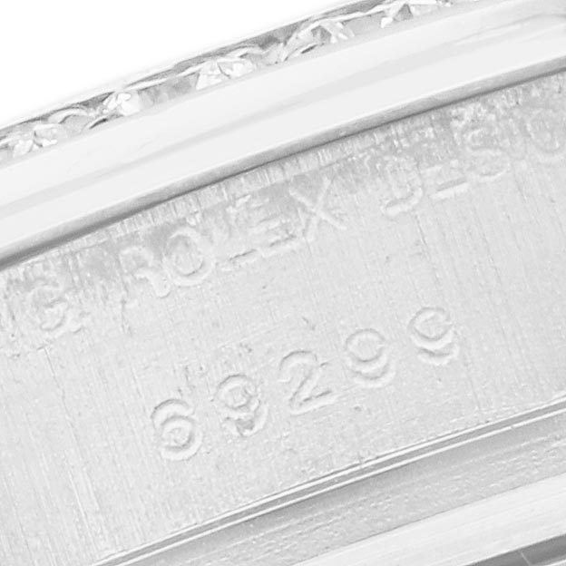 The image shows a close-up of the case side of a Rolex Pearlmaster 69299 Women
s White Gold Mother of Pearl Dial 69299 Women
s White Gold Mother of Pearl Dial, displaying engraved text and the model number.