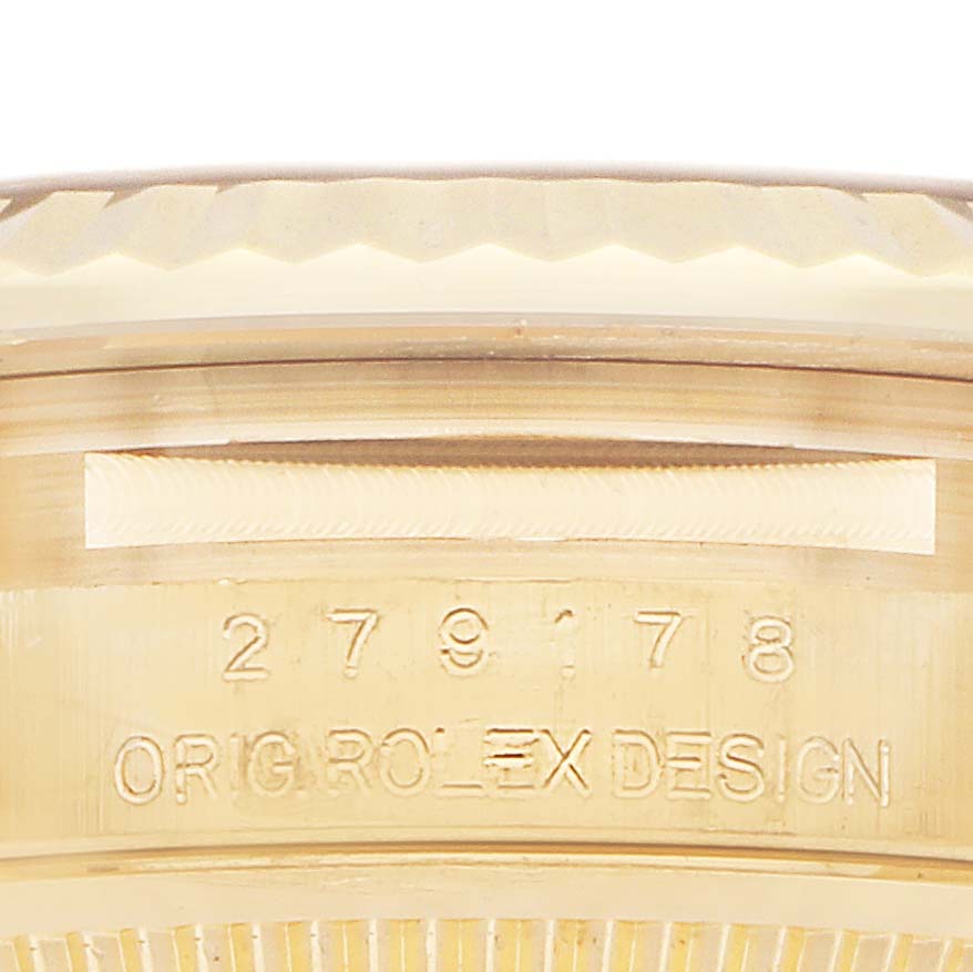 The image shows the side of a Rolex President 279178 Women
s Yellow Gold Silver Dial 279178 Women
s Yellow Gold Silver Dial watch, focusing on part of the case with engraved text and the model number.