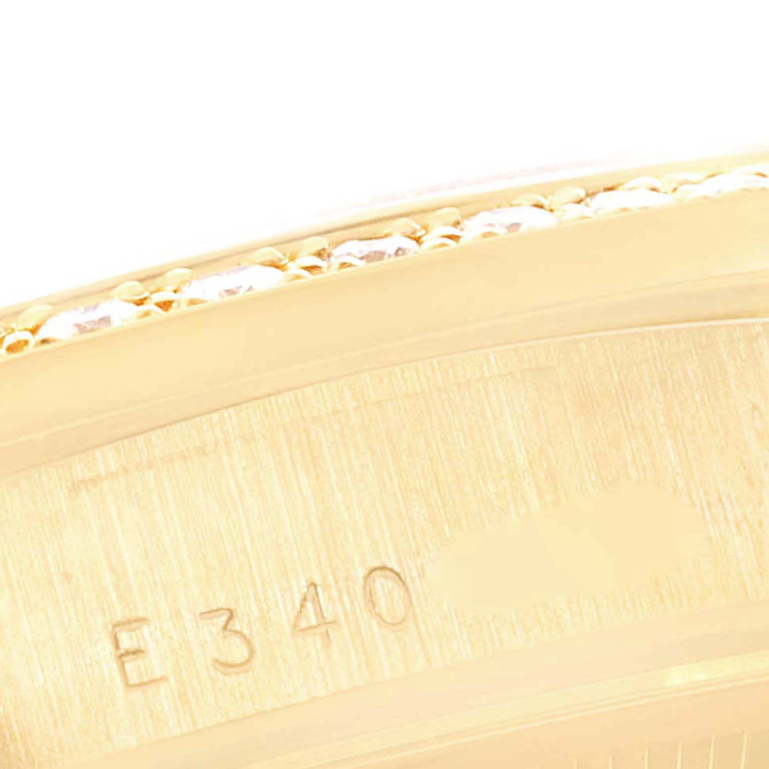 The image shows a close-up angled view of the gold case edge and part of the serial number of a Rolex President 18348 Men's Yellow Gold Champagne Dial 18348 Men's Yellow Gold Champagne Dial model watch.