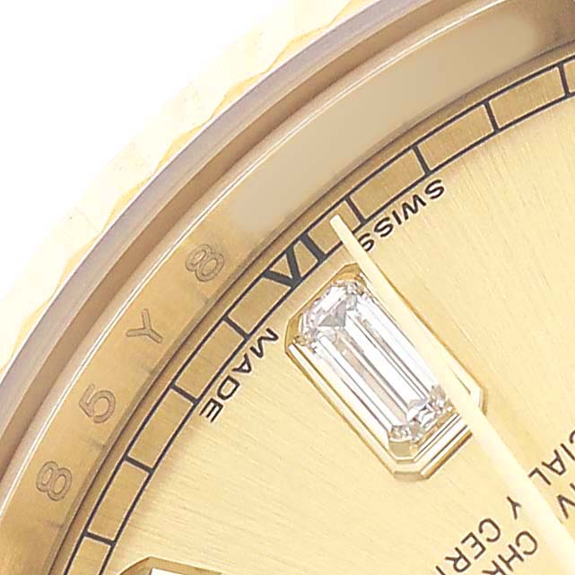 The image shows a close-up of the dial of a Rolex President 118238 Men's Yellow Gold Champagne Dial watch, highlighting a diamond marker and part of the bezel.