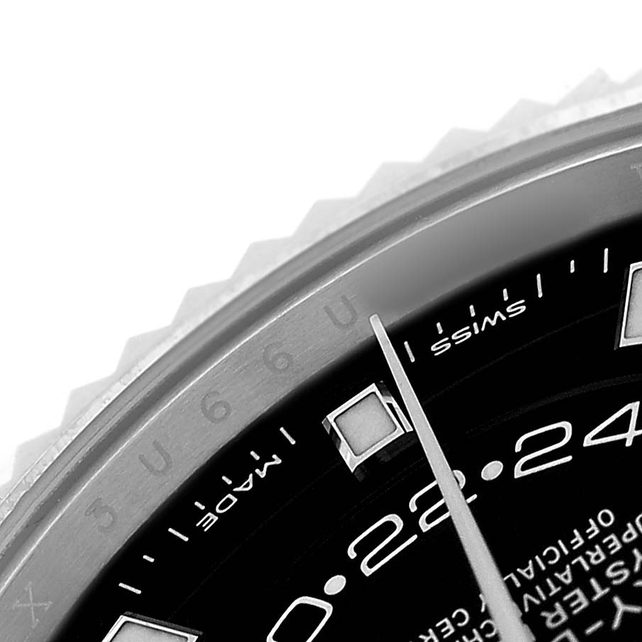 The image shows a close-up of the Rolex Sky-Dweller 326934 Men's Stainless Steel Black Dial dial, focusing on the bezel, hour markers, and part of the hand.