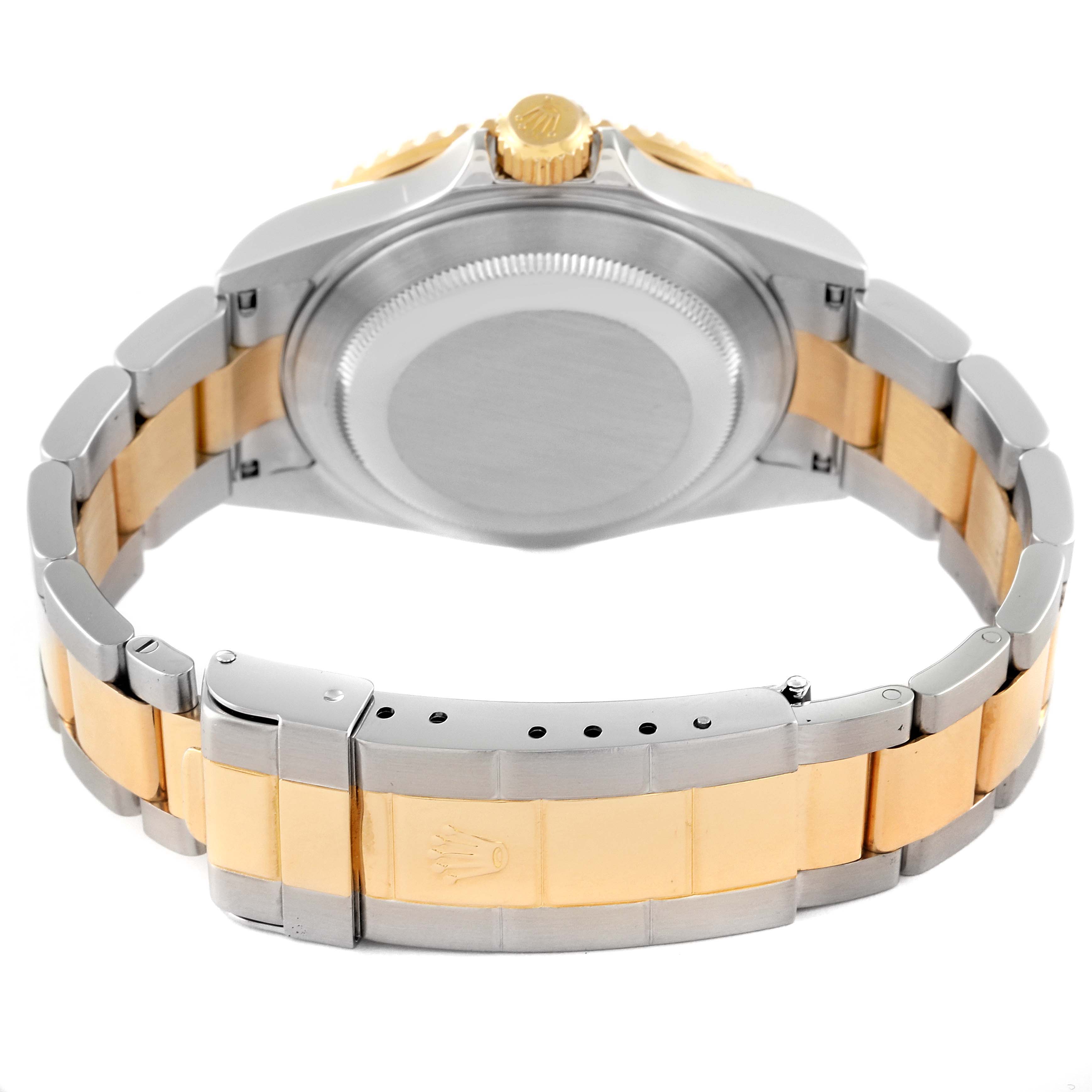 The image shows the back of a Rolex Submariner 16613 Men's Steel and Gold (two tone) Blue Dial 16613 Men's Steel and Gold (two tone) Blue Dial watch, highlighting its case back, two-tone bracelet, and clasp.